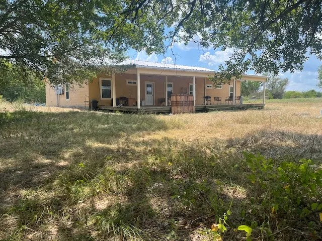 Large covered porch on back of property