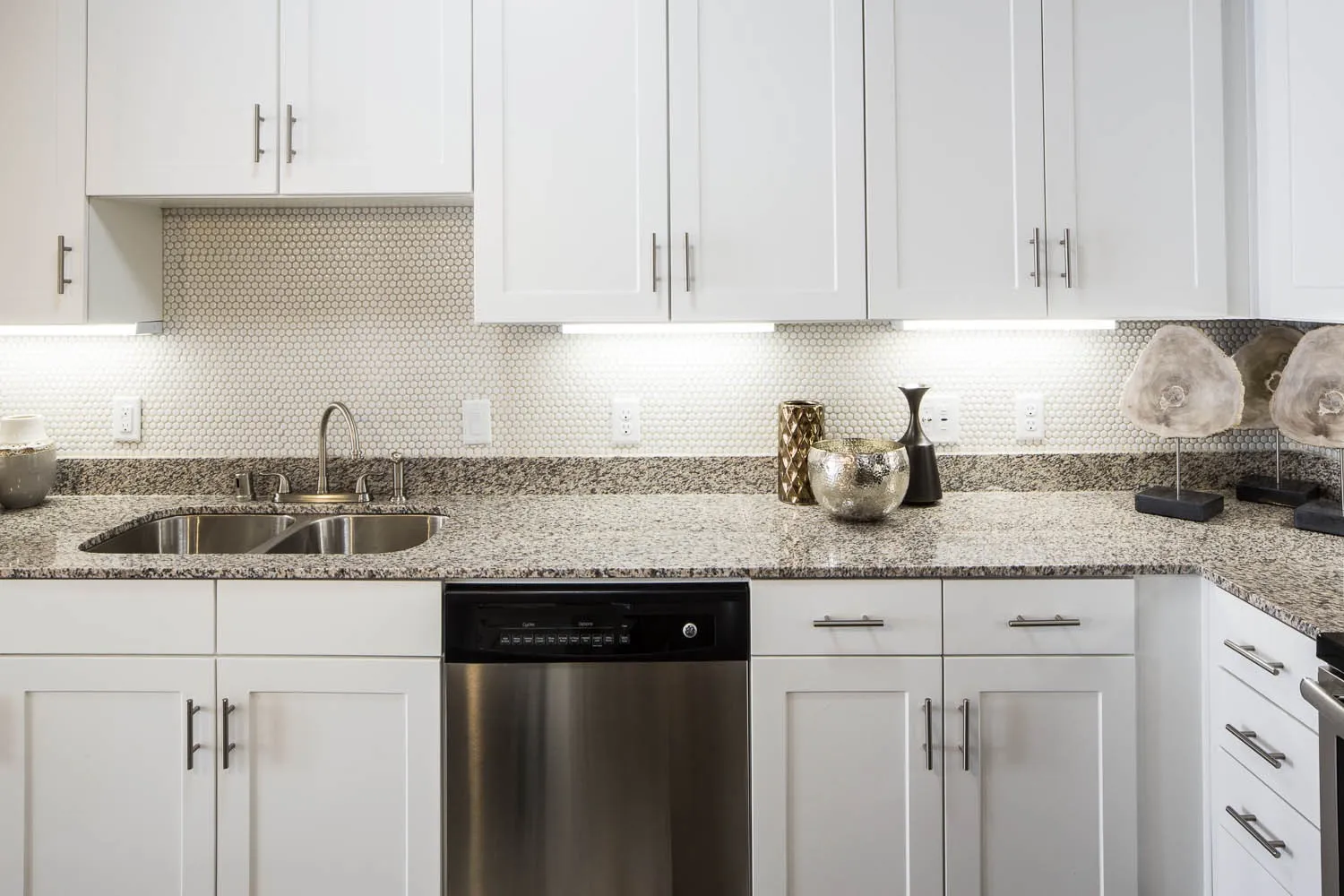 Kitchen featuring backsplash and white cabinetry