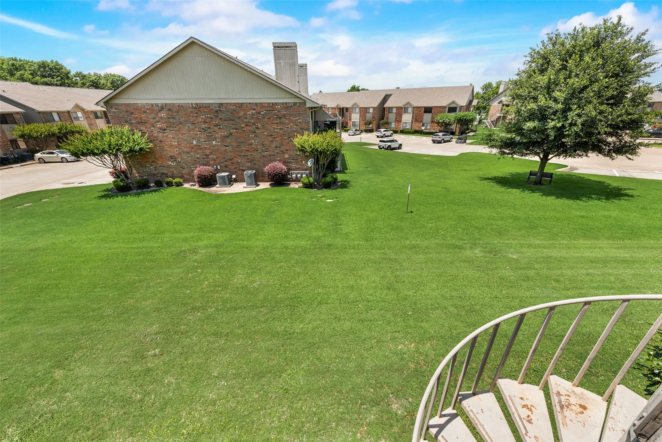 View of grassy yard with a patio and a residential view