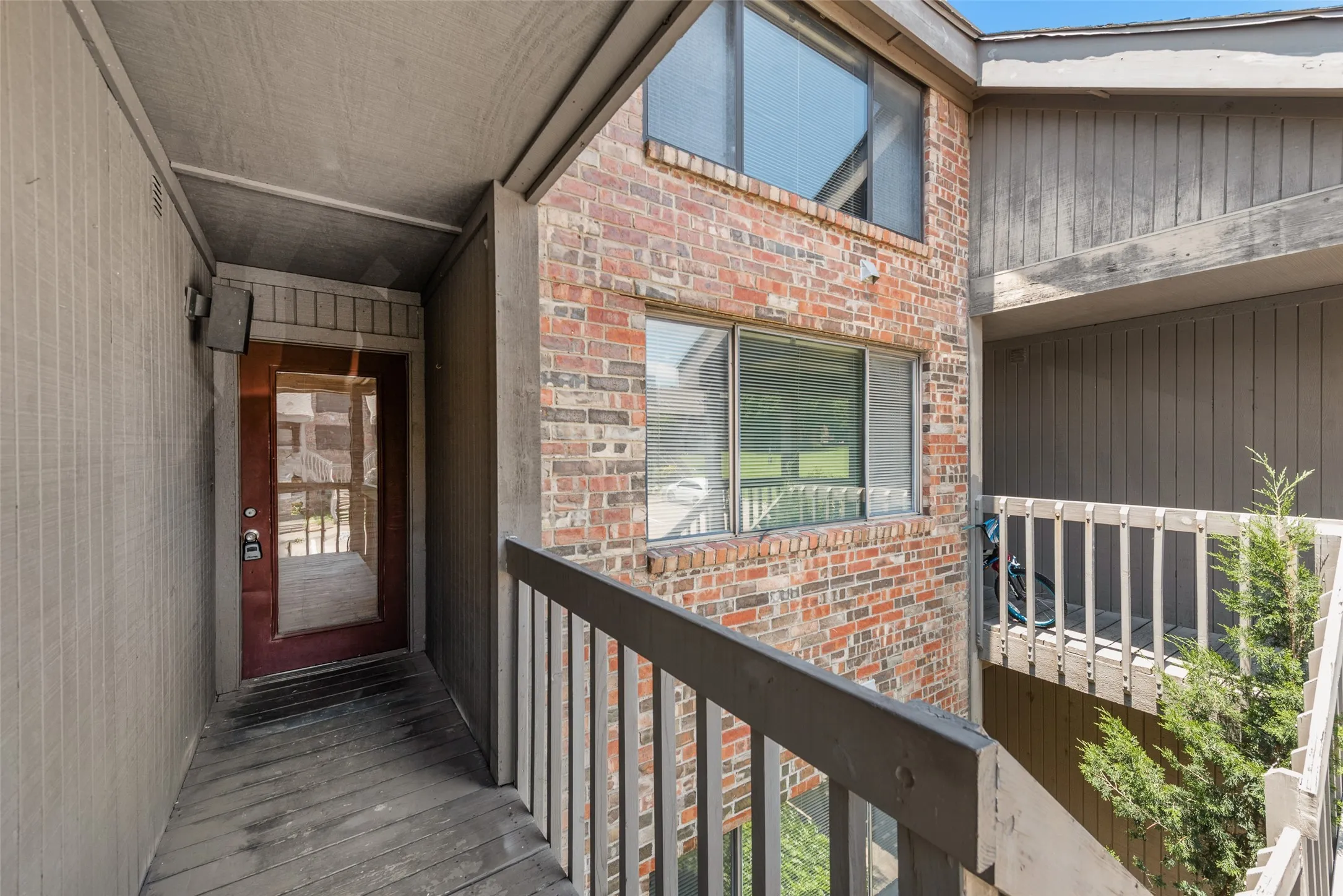 Property entrance featuring brick siding