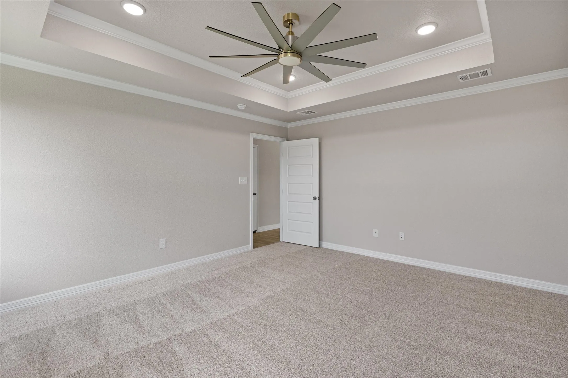 Tray ceiling with recessed lighting and crown molding