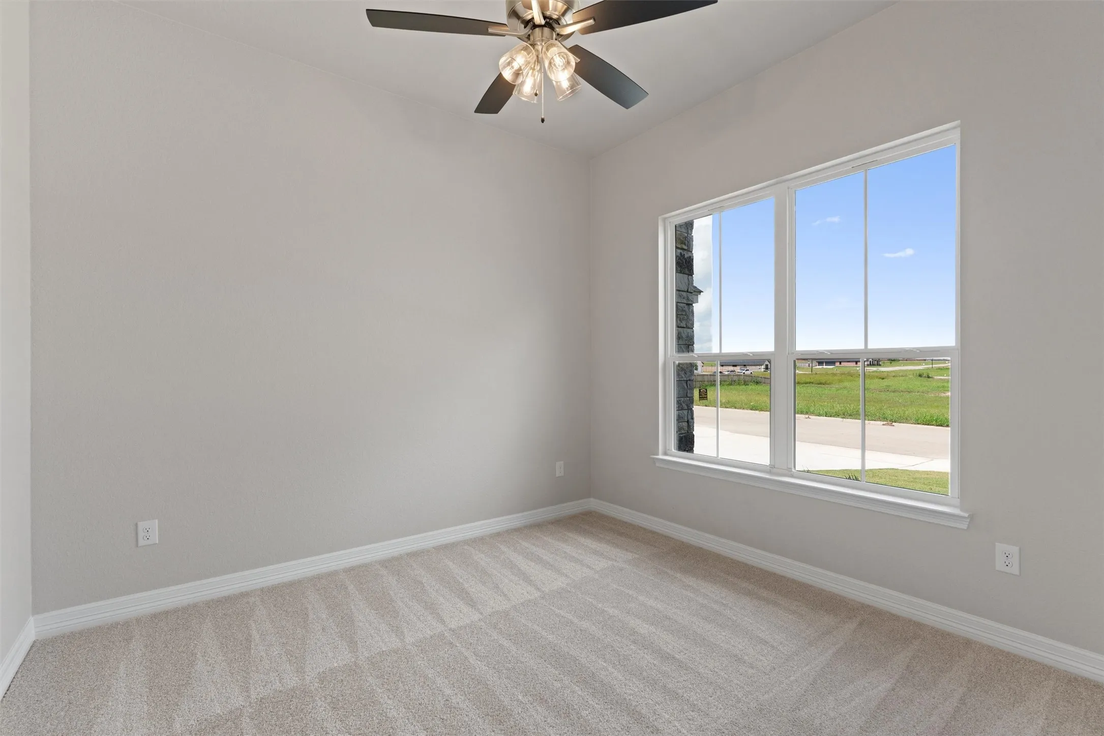 Neutral-toned walls complement the light-colored patterned carpeting