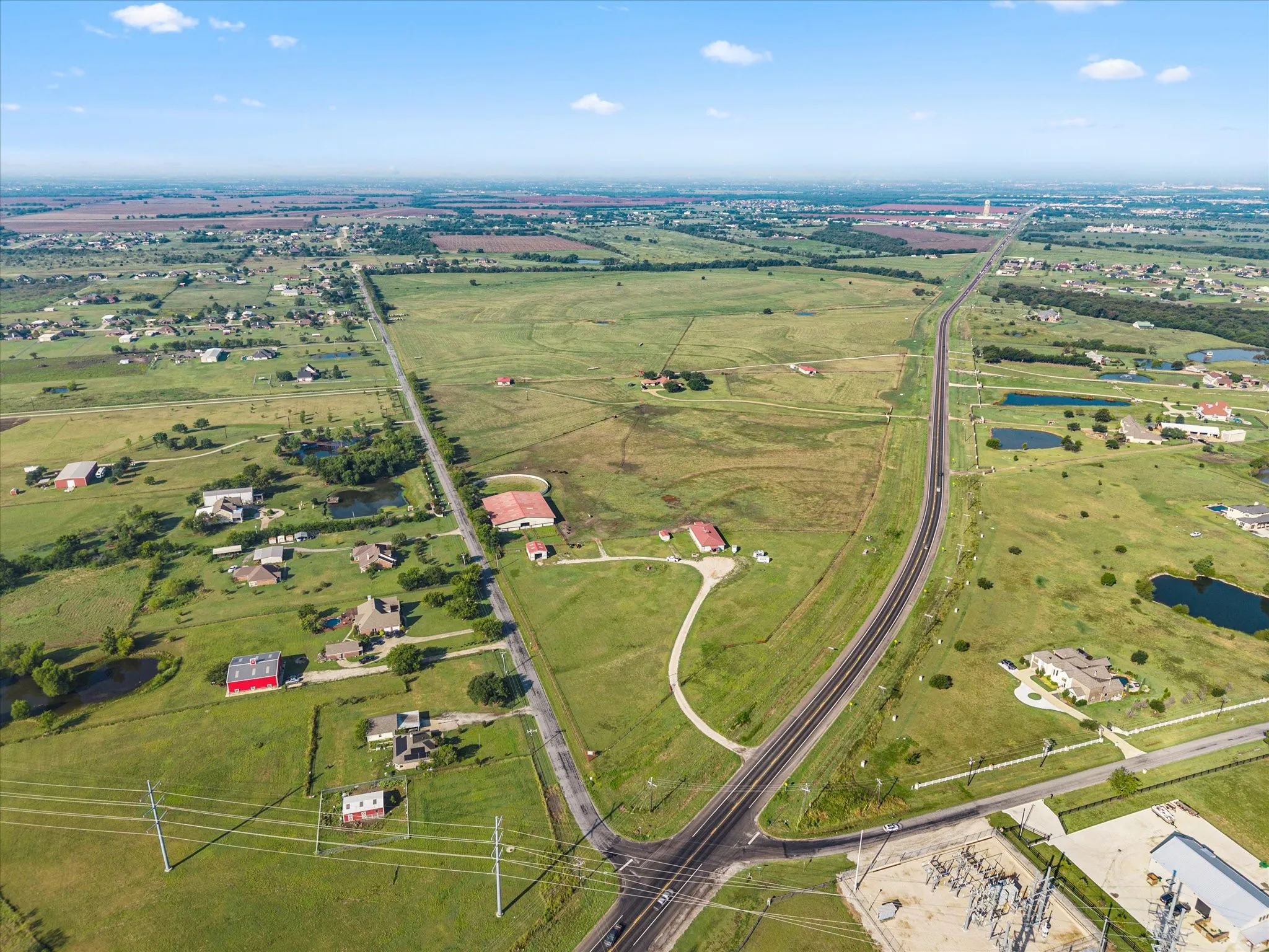 Wide-open landscape views showcasing the property’s scale, fencing, and development potential.