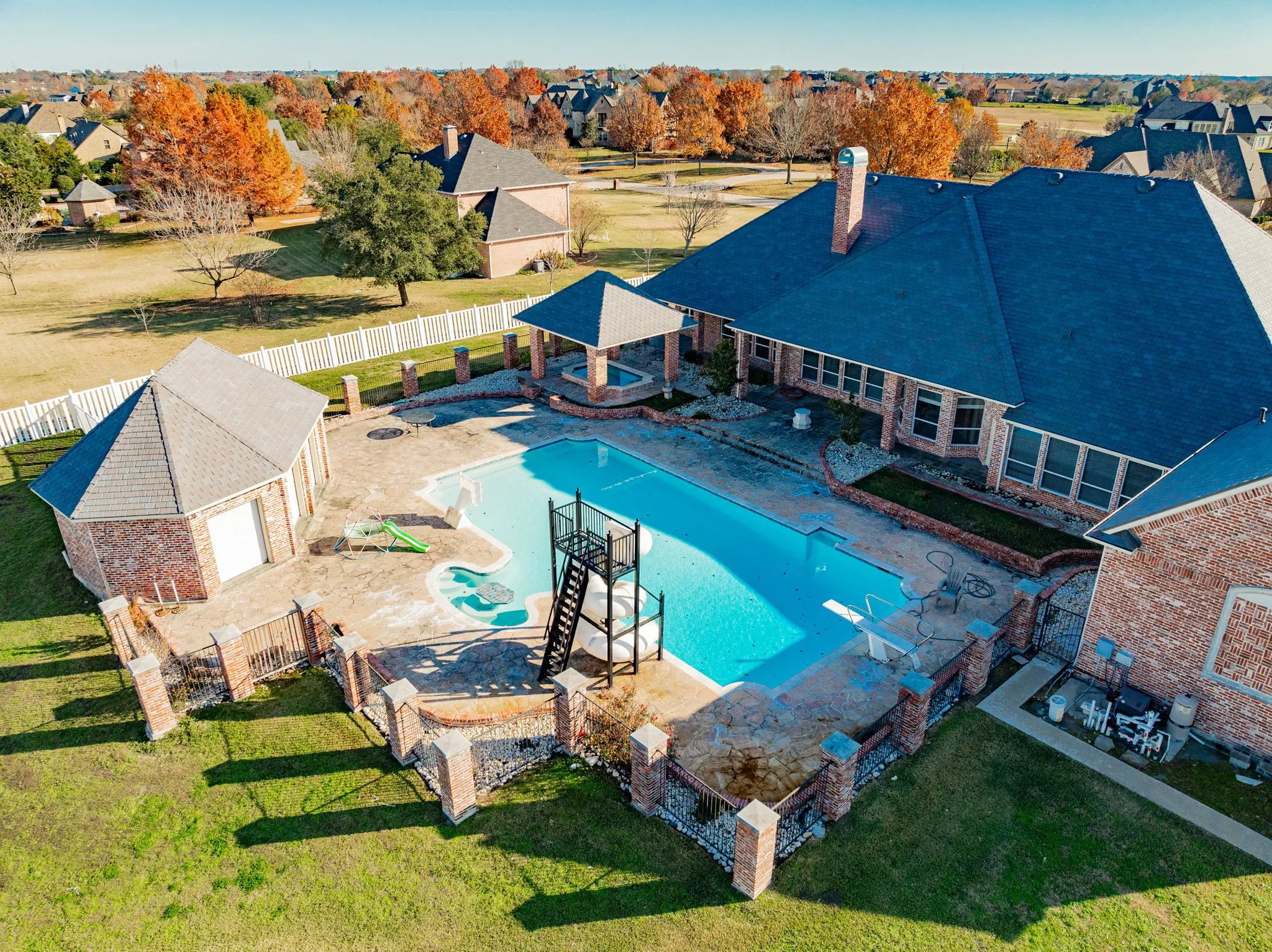 View of swimming pool featuring a patio and a hot tub