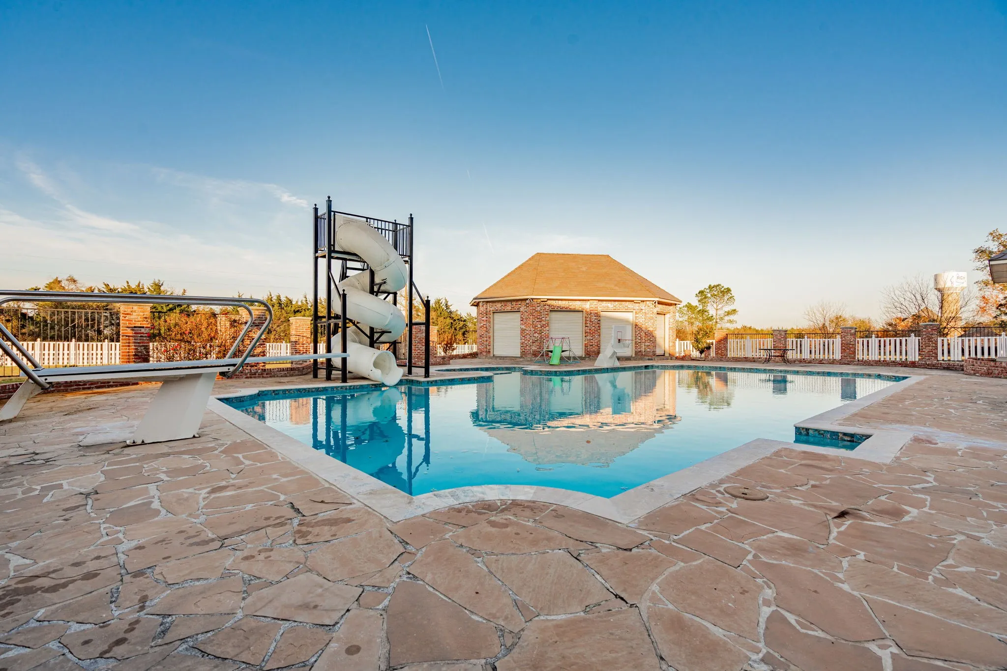 View of swimming pool with a patio area and a water slide