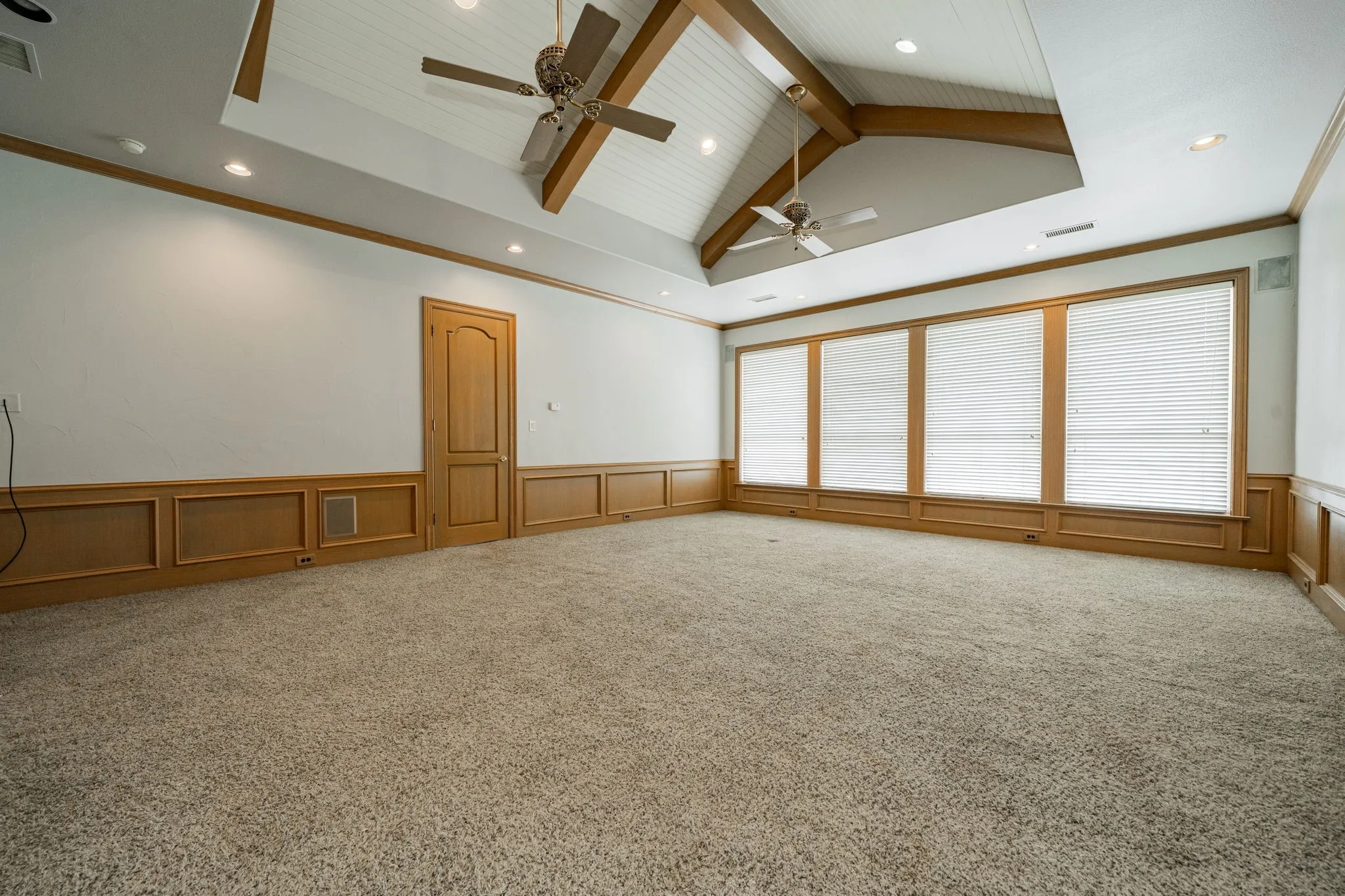 Unfurnished room with beam ceiling, recessed lighting, light colored carpet, crown molding, and high vaulted ceiling