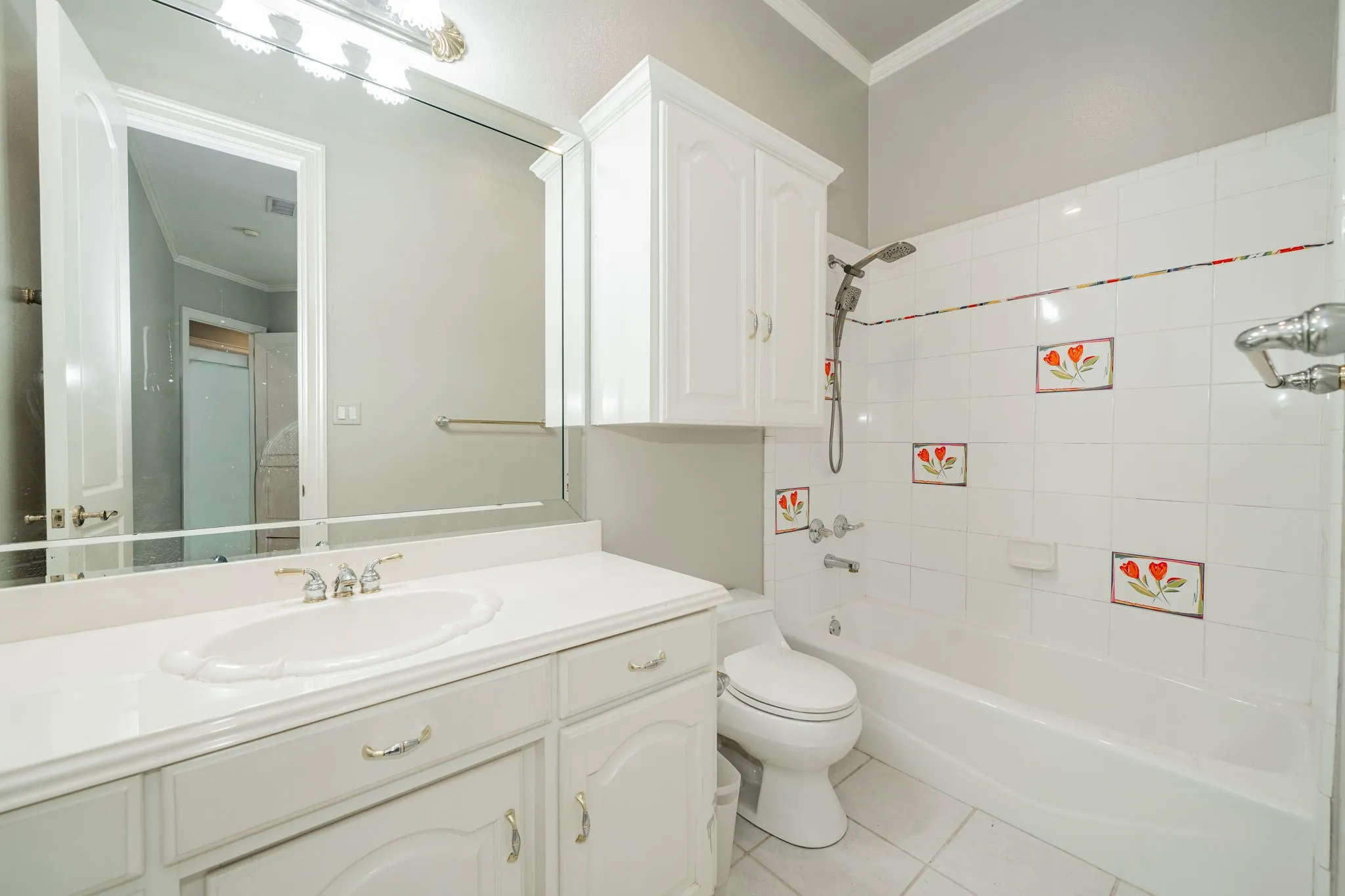 Bathroom with shower / washtub combination, crown molding, light tile patterned floors, and vanity