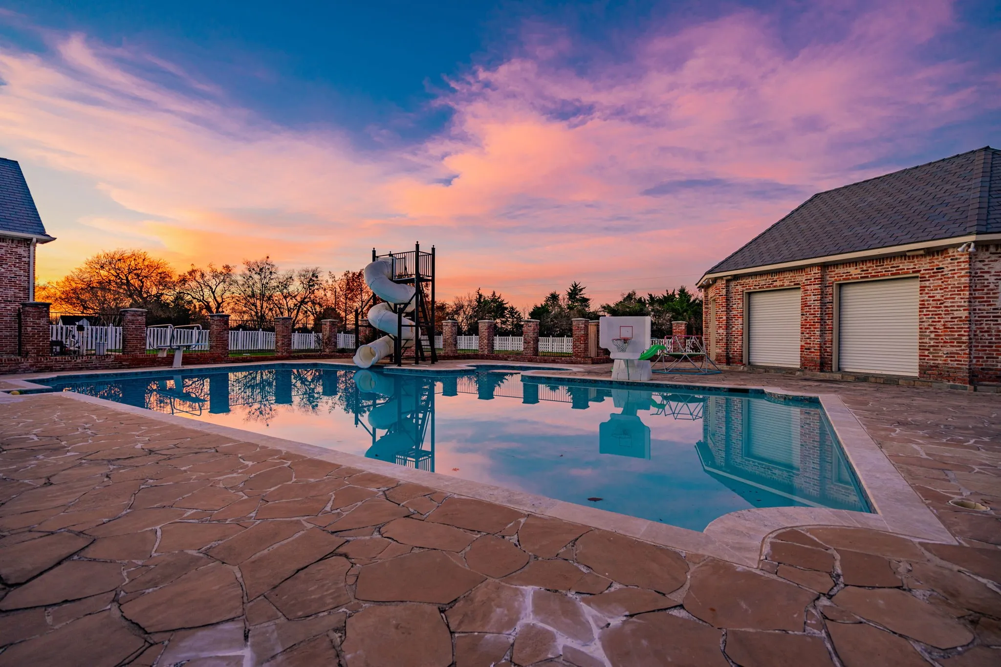 View of pool featuring a water slide and a patio area