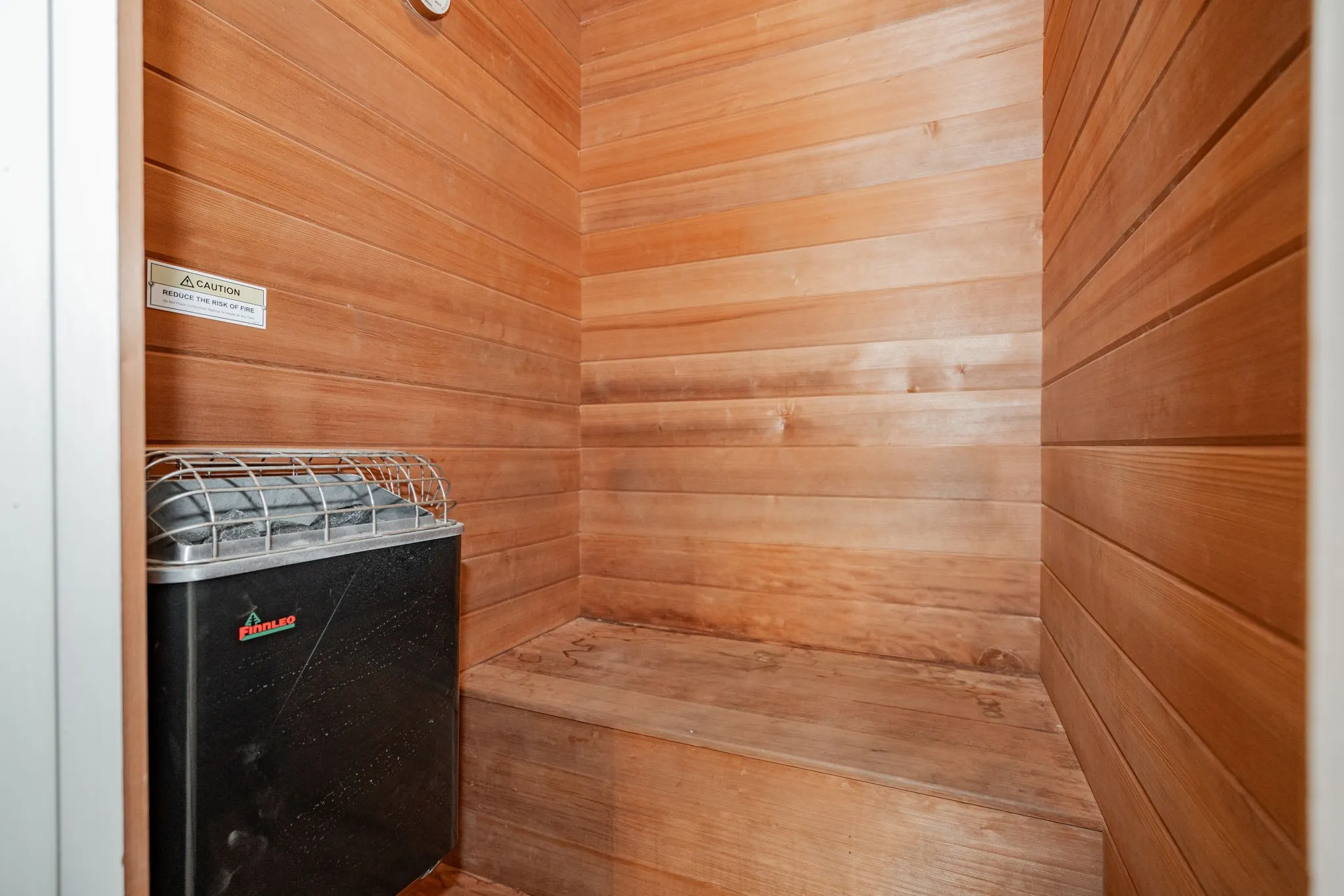 Relaxing sauna / steam room featuring wooden walls
