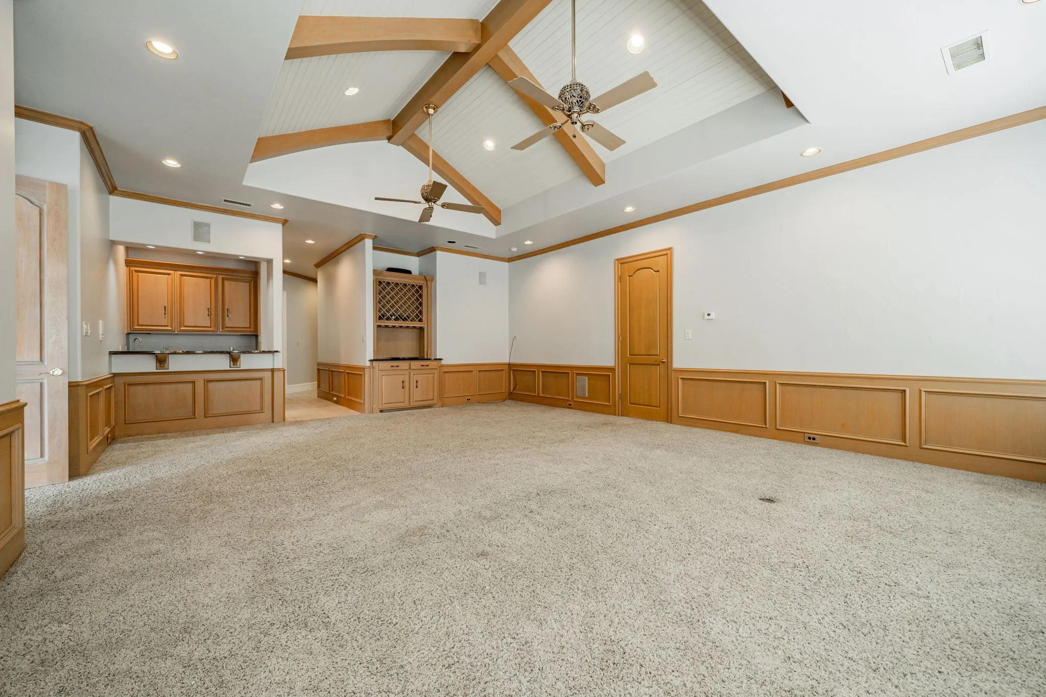 Unfurnished living room featuring beam ceiling, high vaulted ceiling, light colored carpet, recessed lighting, and a ceiling fan