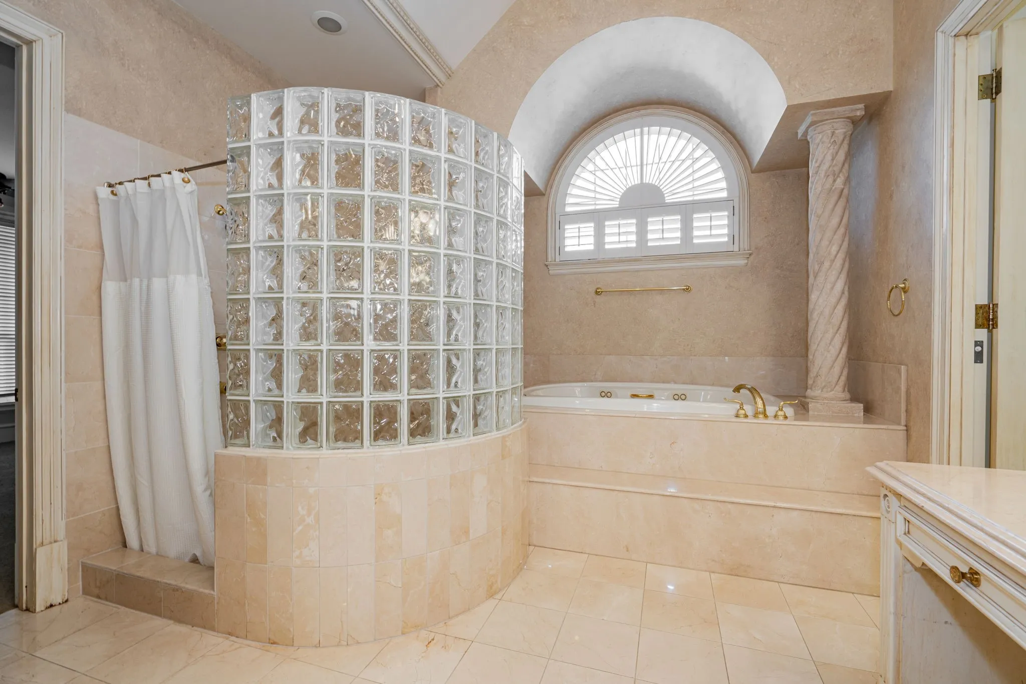 Bathroom featuring a shower stall, a garden tub, tile patterned flooring, tile walls, and vanity