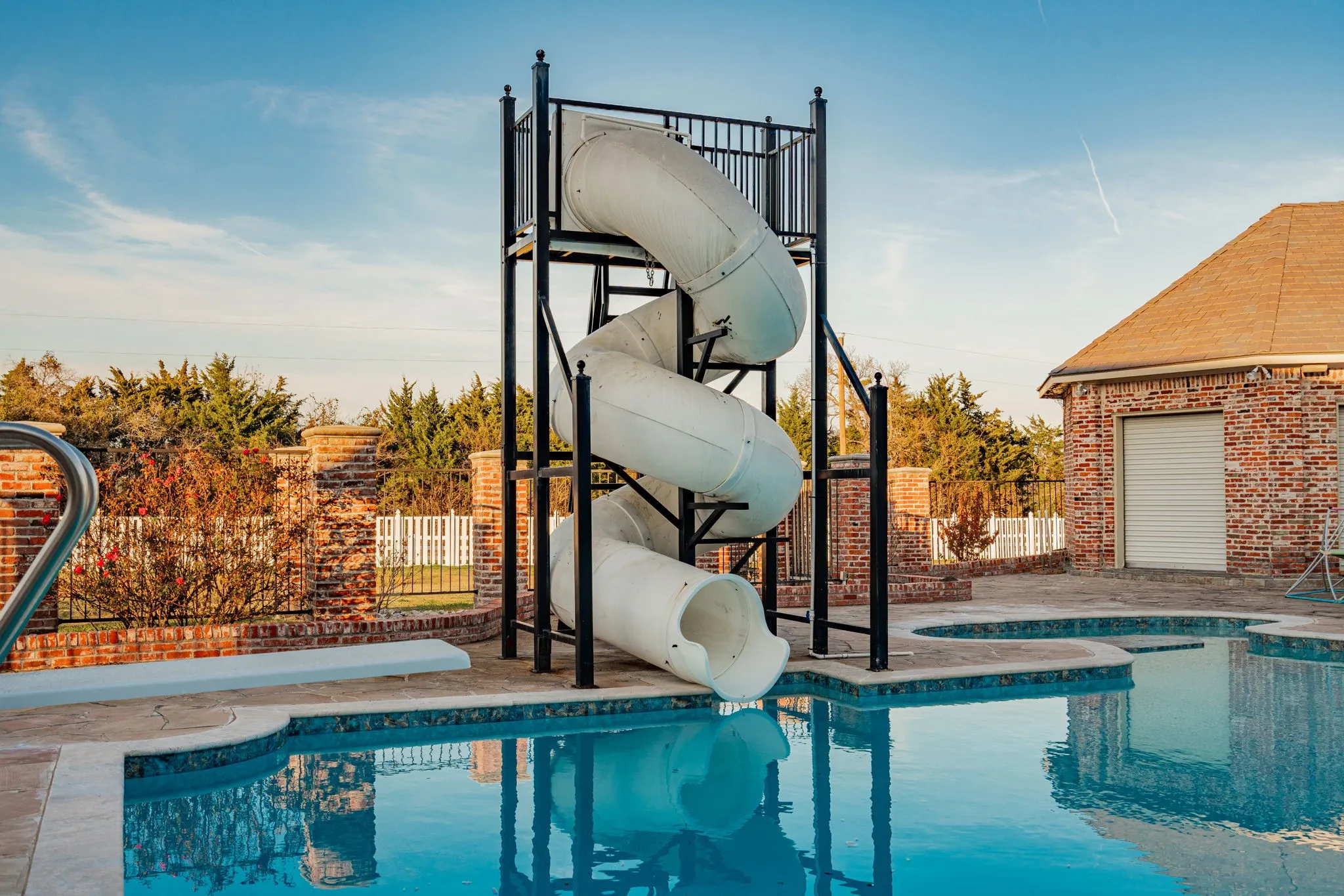 View of pool featuring a water slide and a patio