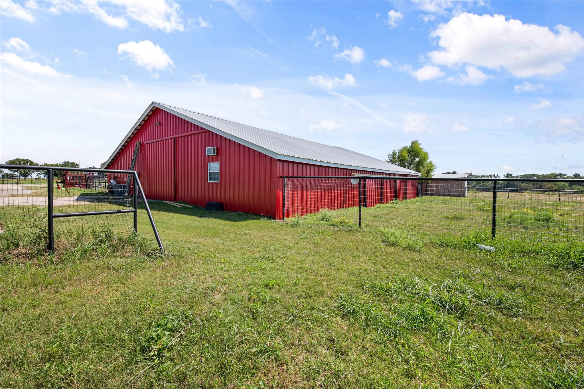 Expansive workshop and barn with a combination dirt and concrete floor.