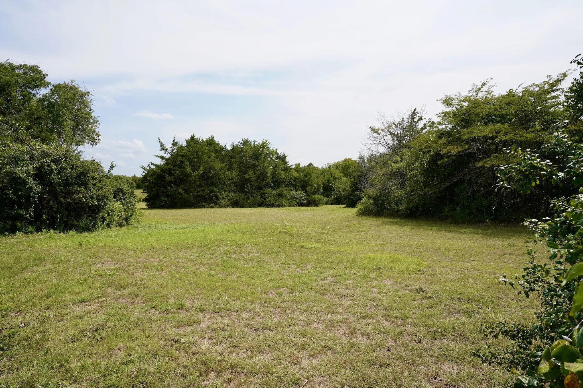 View of green lawn with a view of countryside