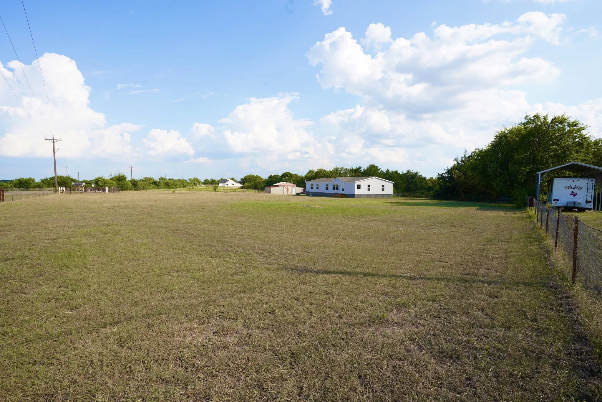View of yard with a view of rural / pastoral area and a carport