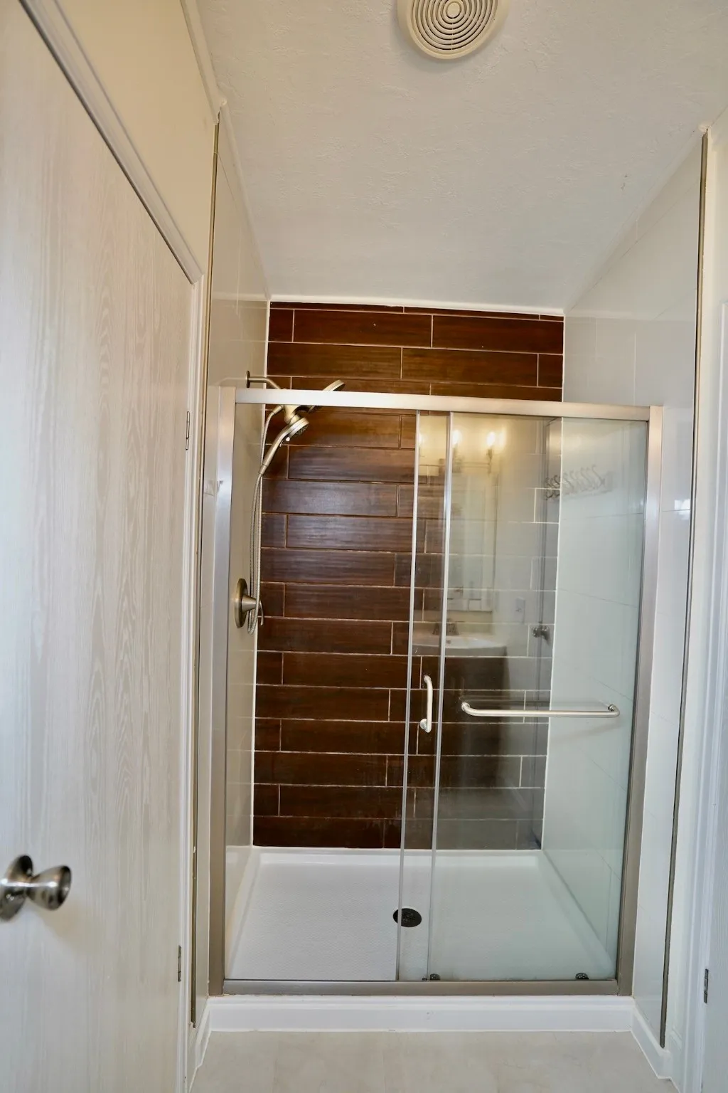 Full bath featuring a shower stall