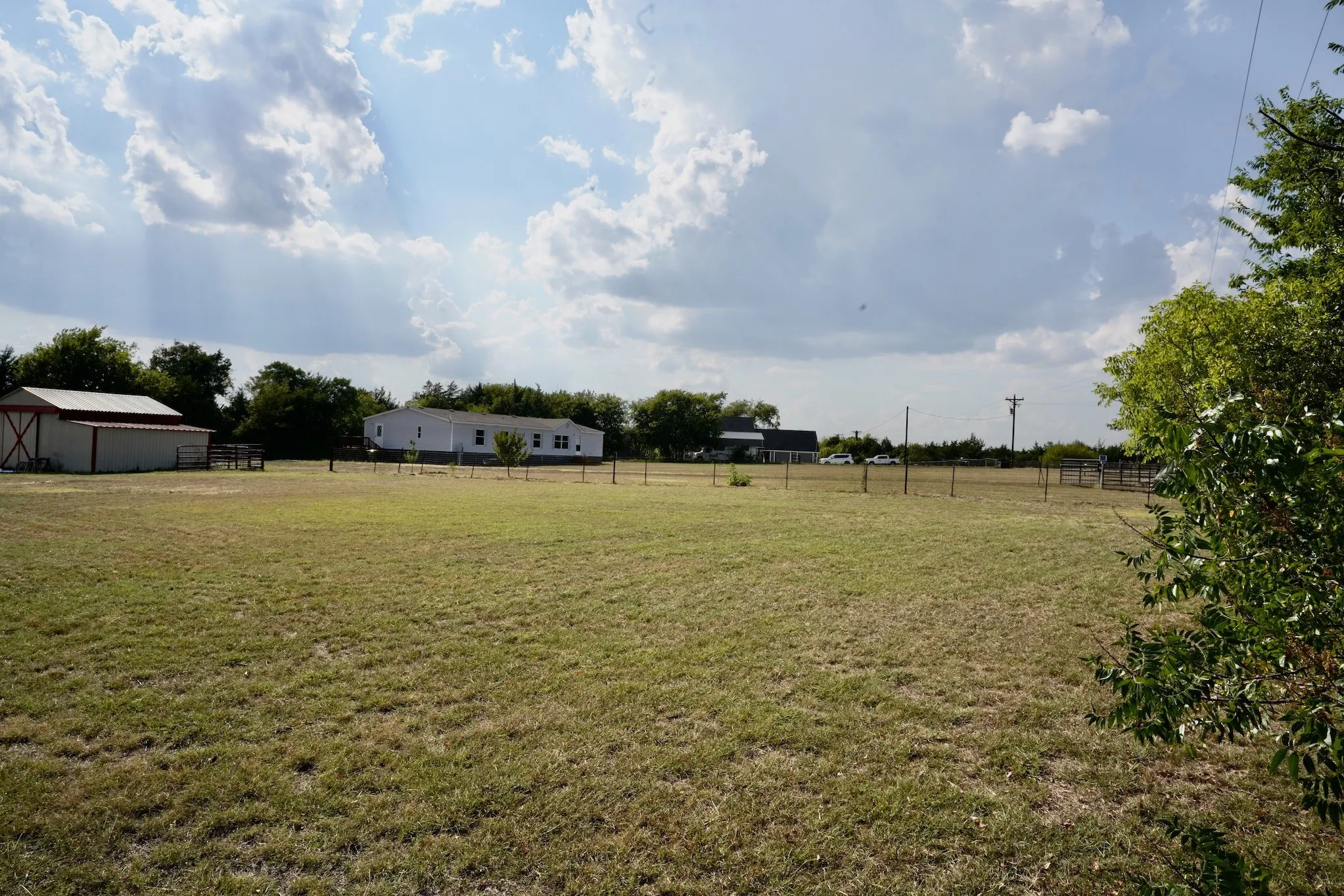 View of yard featuring a rural view and an outdoor structure