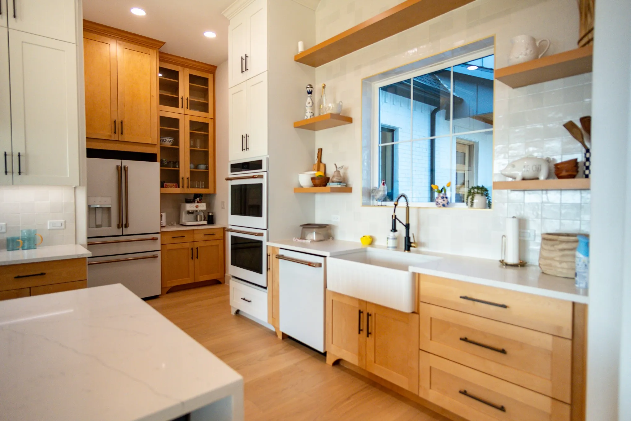 Kitchen with open shelves, tasteful backsplash, white appliances, light stone countertops, and recessed lighting