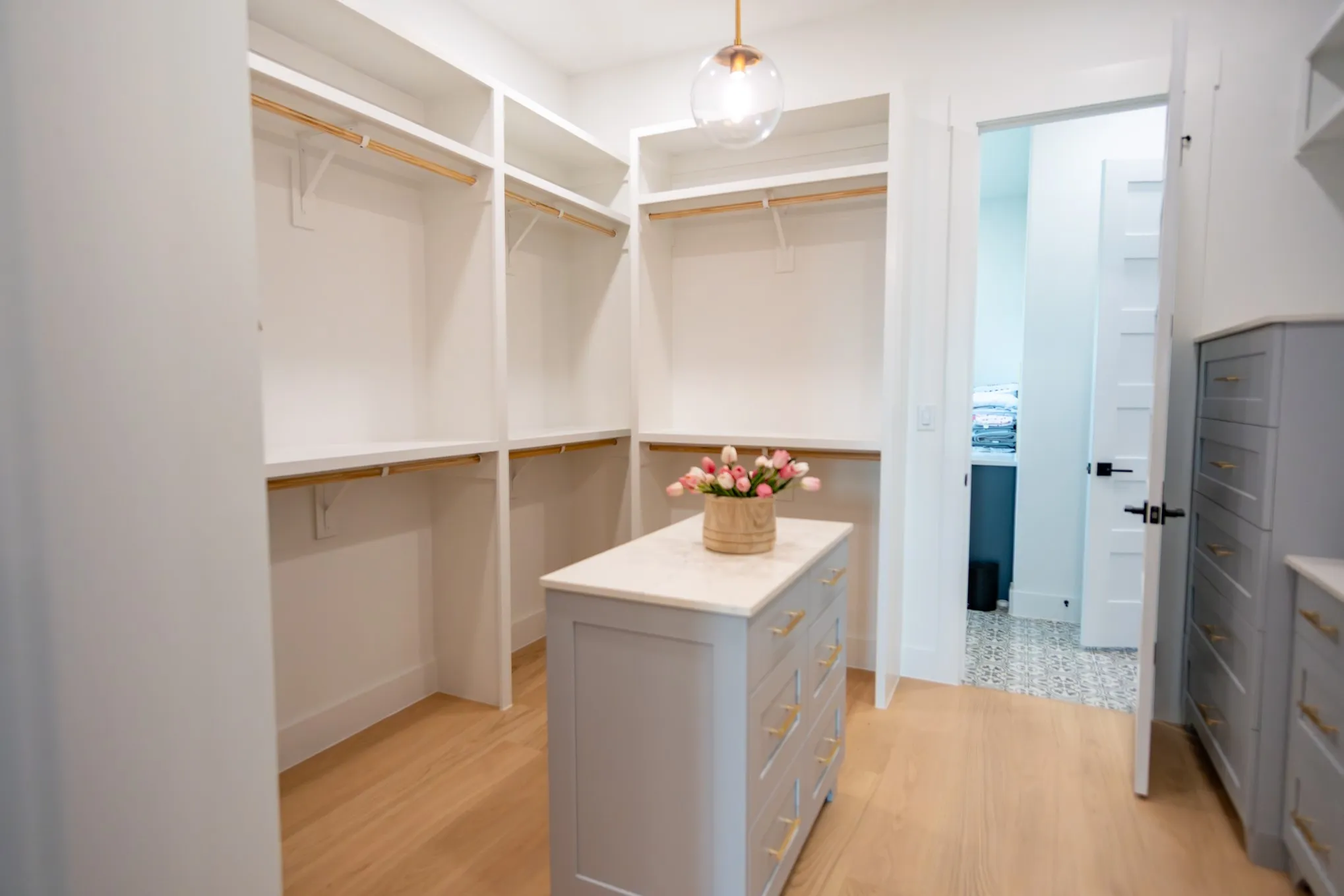 Walk in closet featuring light wood-style floors