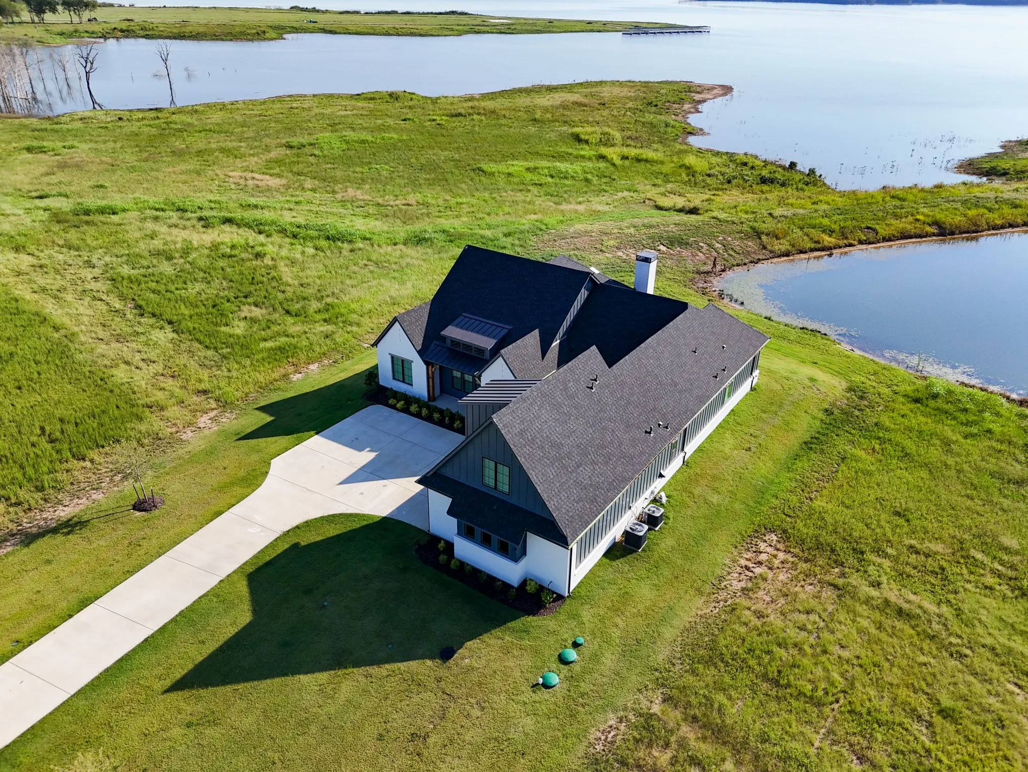 Aerial view of property and surrounding area featuring a large body of water