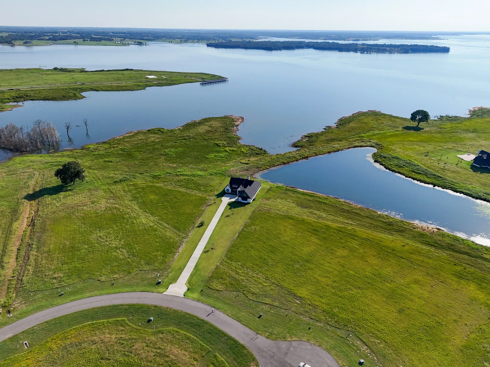 Aerial view of property and surrounding area with a nearby body of water