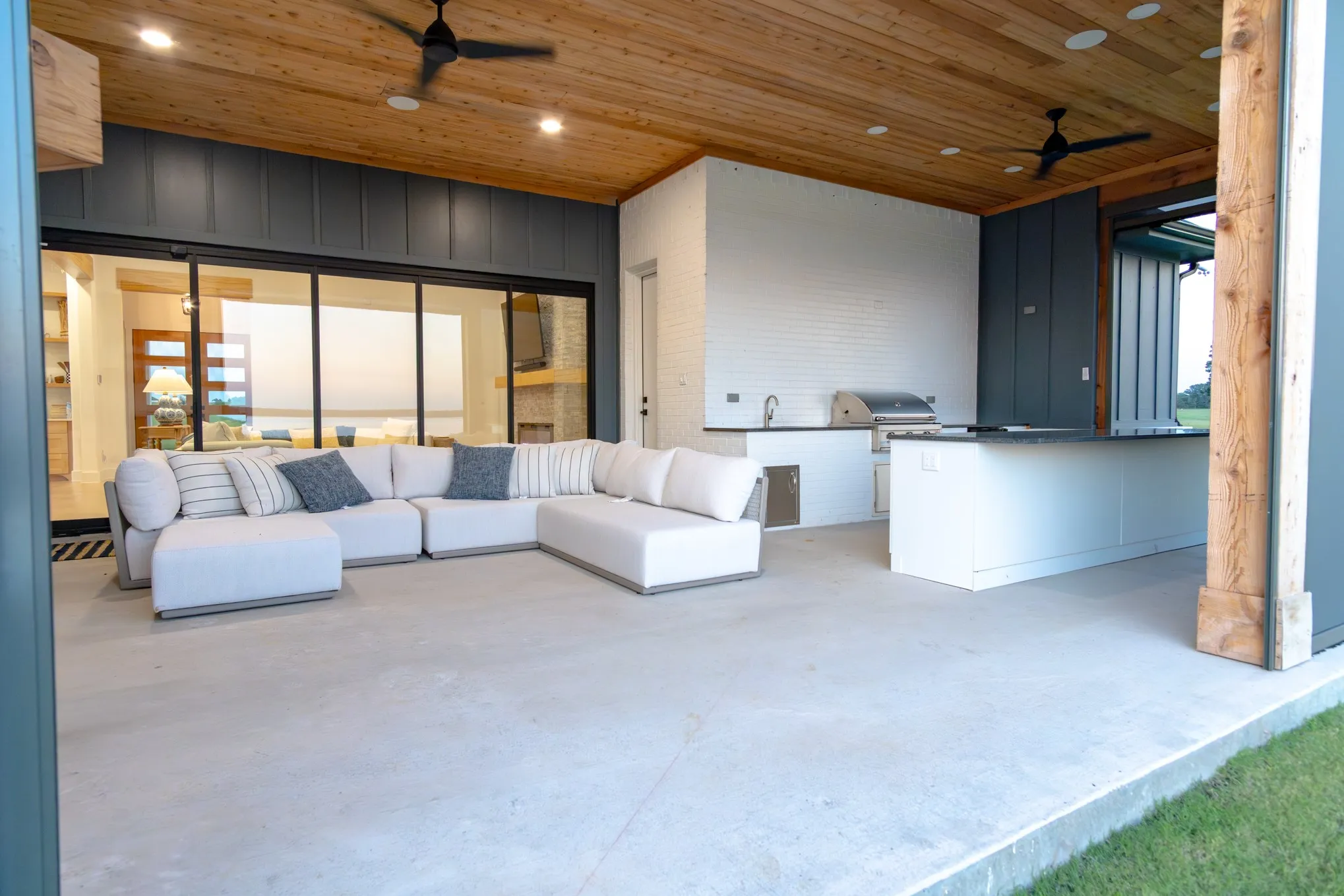 View of patio with ceiling fan, exterior kitchen, and outdoor lounge area
