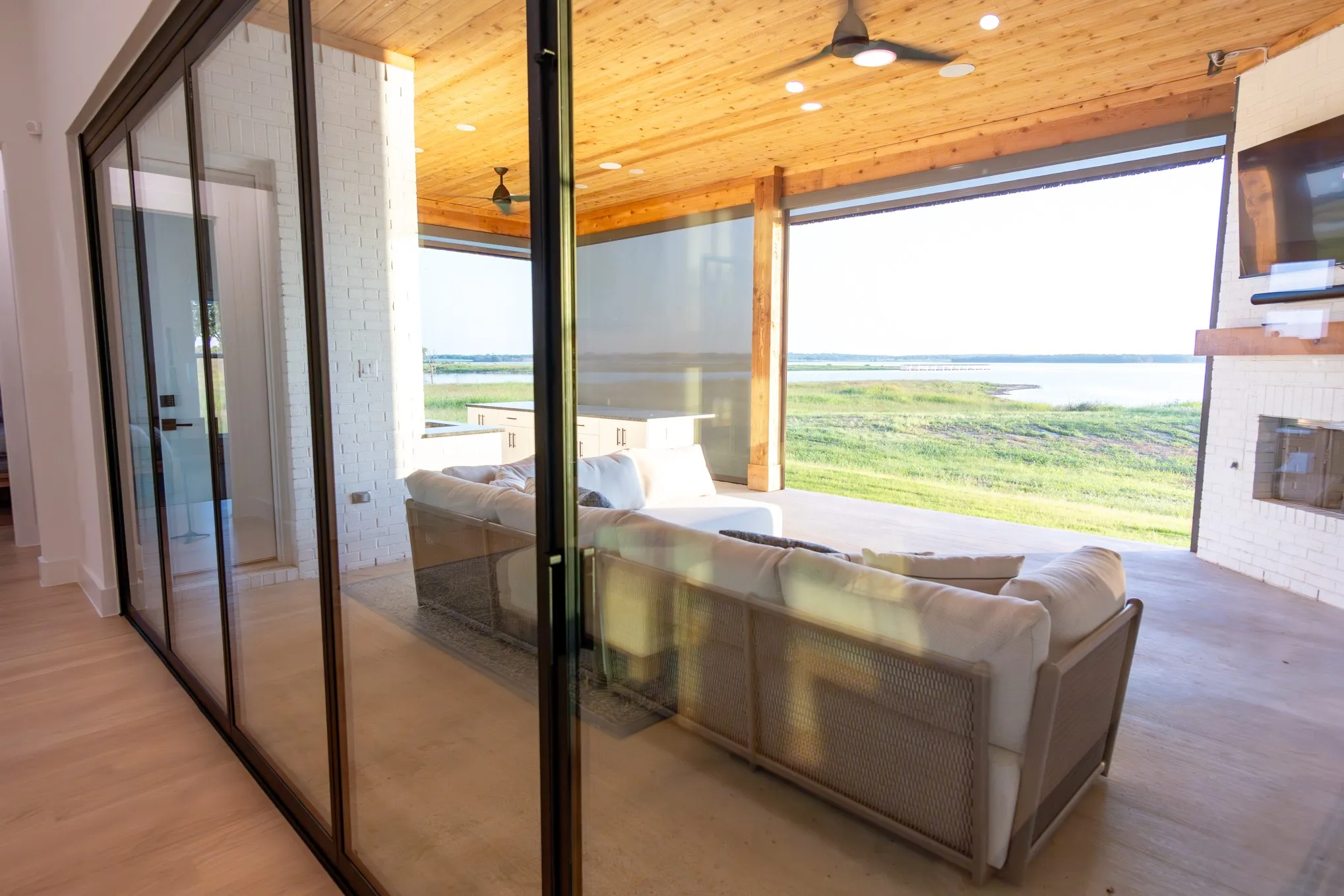 Doorway featuring ceiling fan, wood ceiling, wood finished floors, and a fireplace