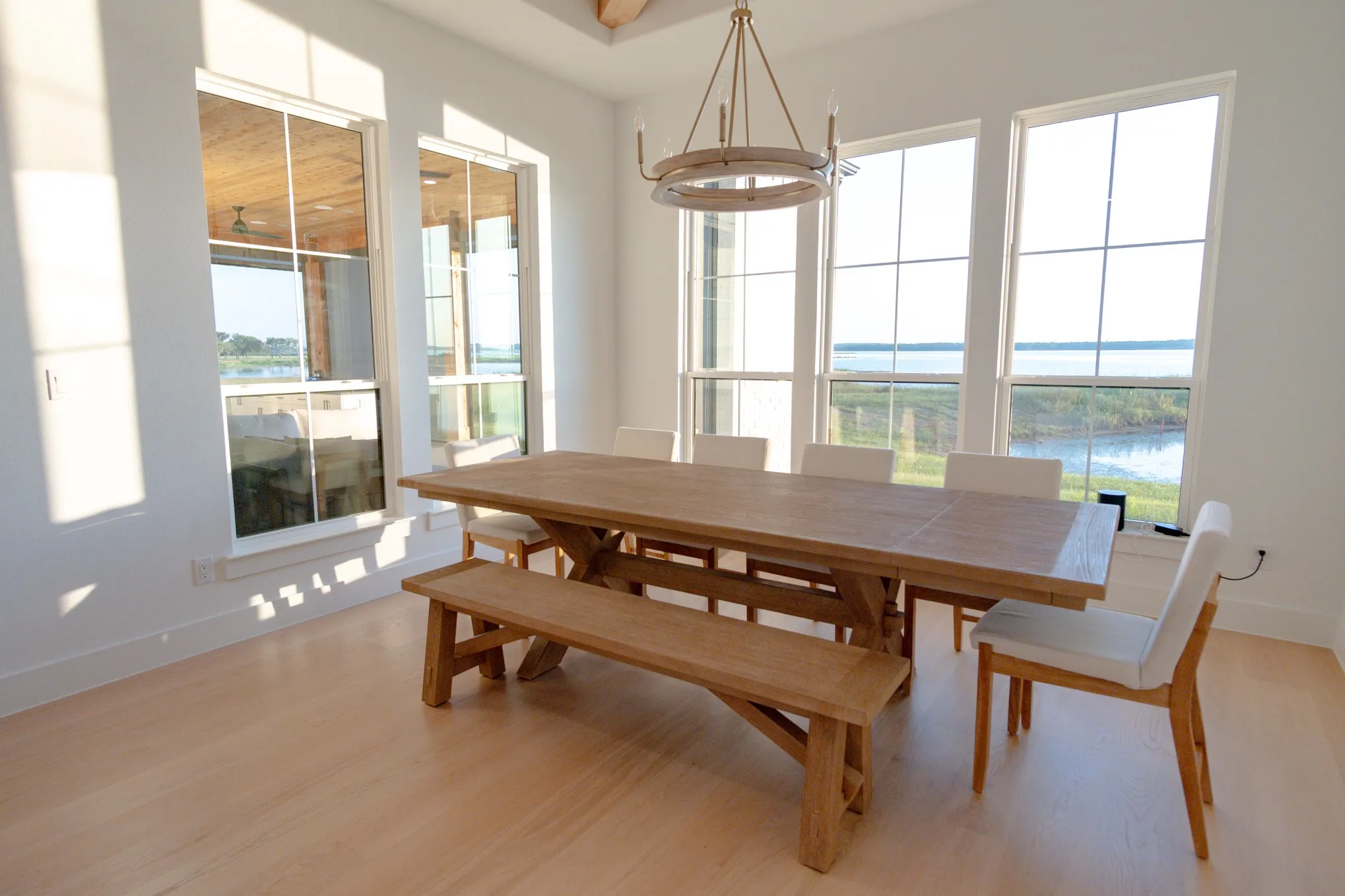 Dining room featuring a water view, light wood-style floors, and a chandelier