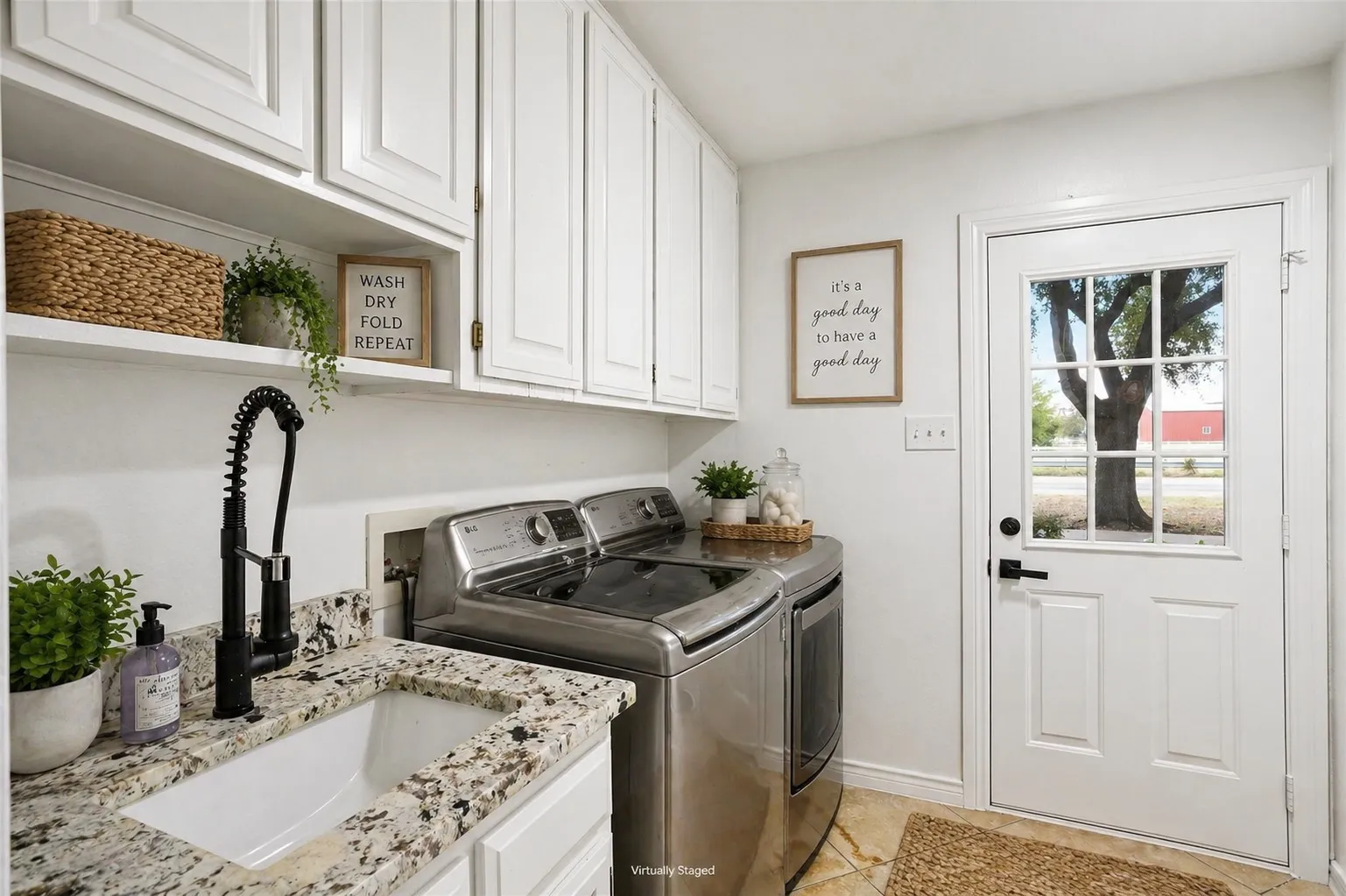 Laundry room on the 1st floor, 3 laundry chutes from above. Has its own exterior door for a mud room entry, built in cabinetry and a drip-dry area