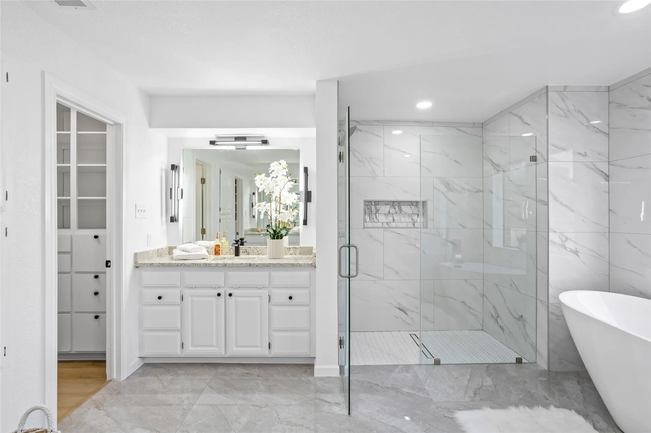 Gorgeous primary bathroom with 2 separate walk-in closets. Coveted set up