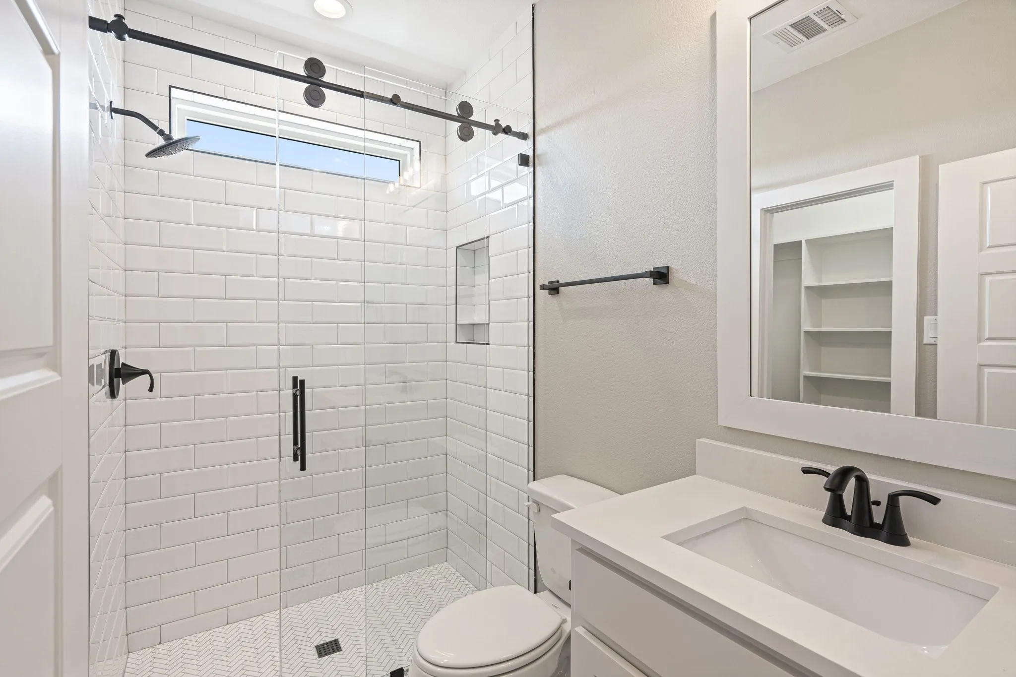 Bath 2 located inside bedroom 2 with shower & frameless barnstyle shower door
