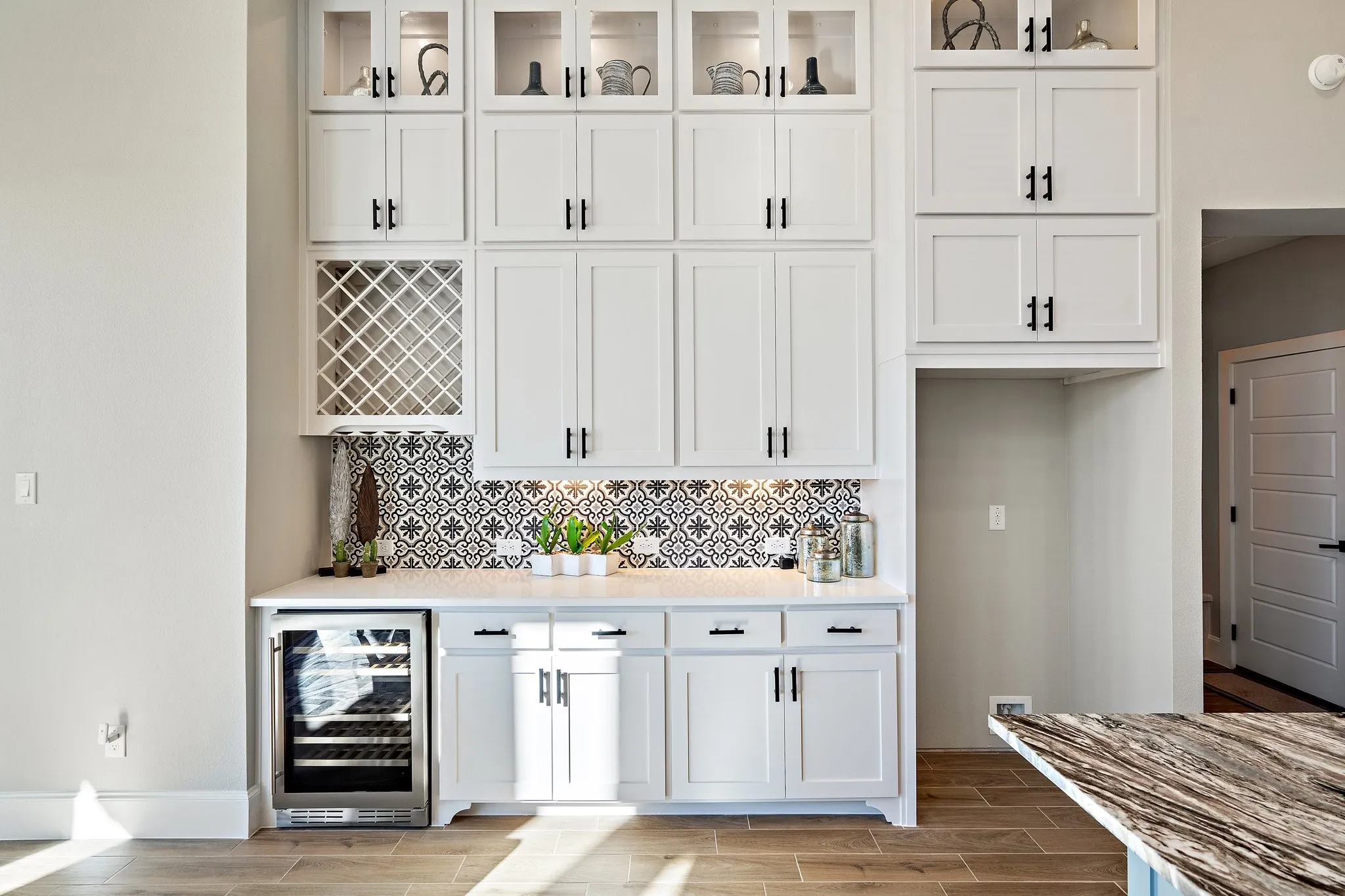 Plenty of cabinets for storage & fridge with wine rack