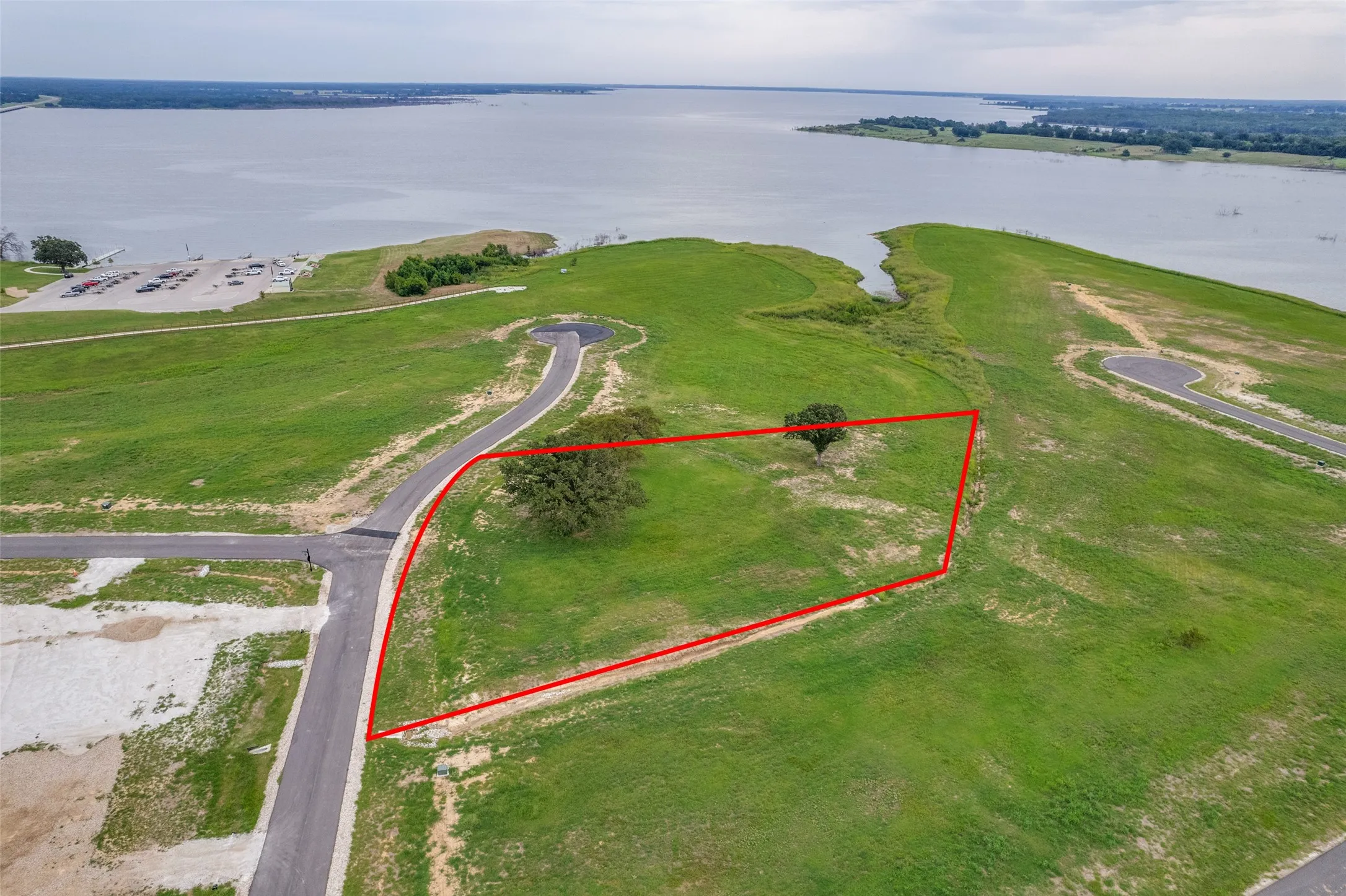 Aerial overview of property's location with property boundaries highlighted and a nearby body of water