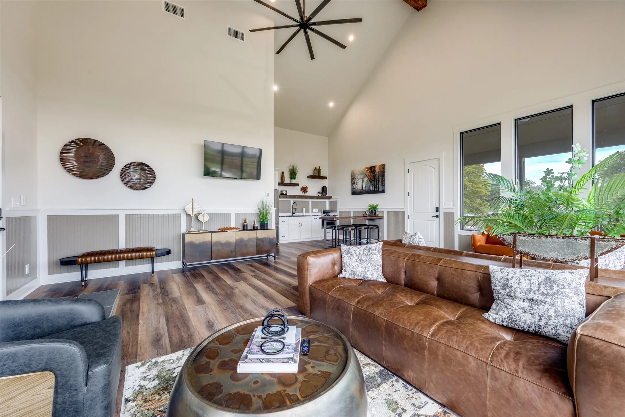 Living room featuring high vaulted ceiling, wood finished floors, recessed lighting, and beamed ceiling