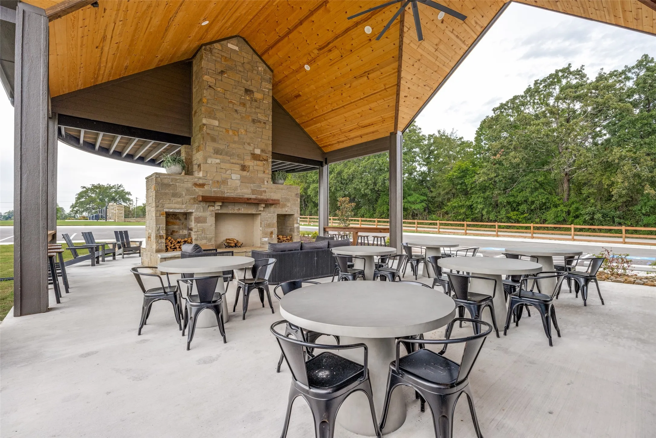 View of patio / terrace featuring an outdoor stone fireplace and outdoor dining area