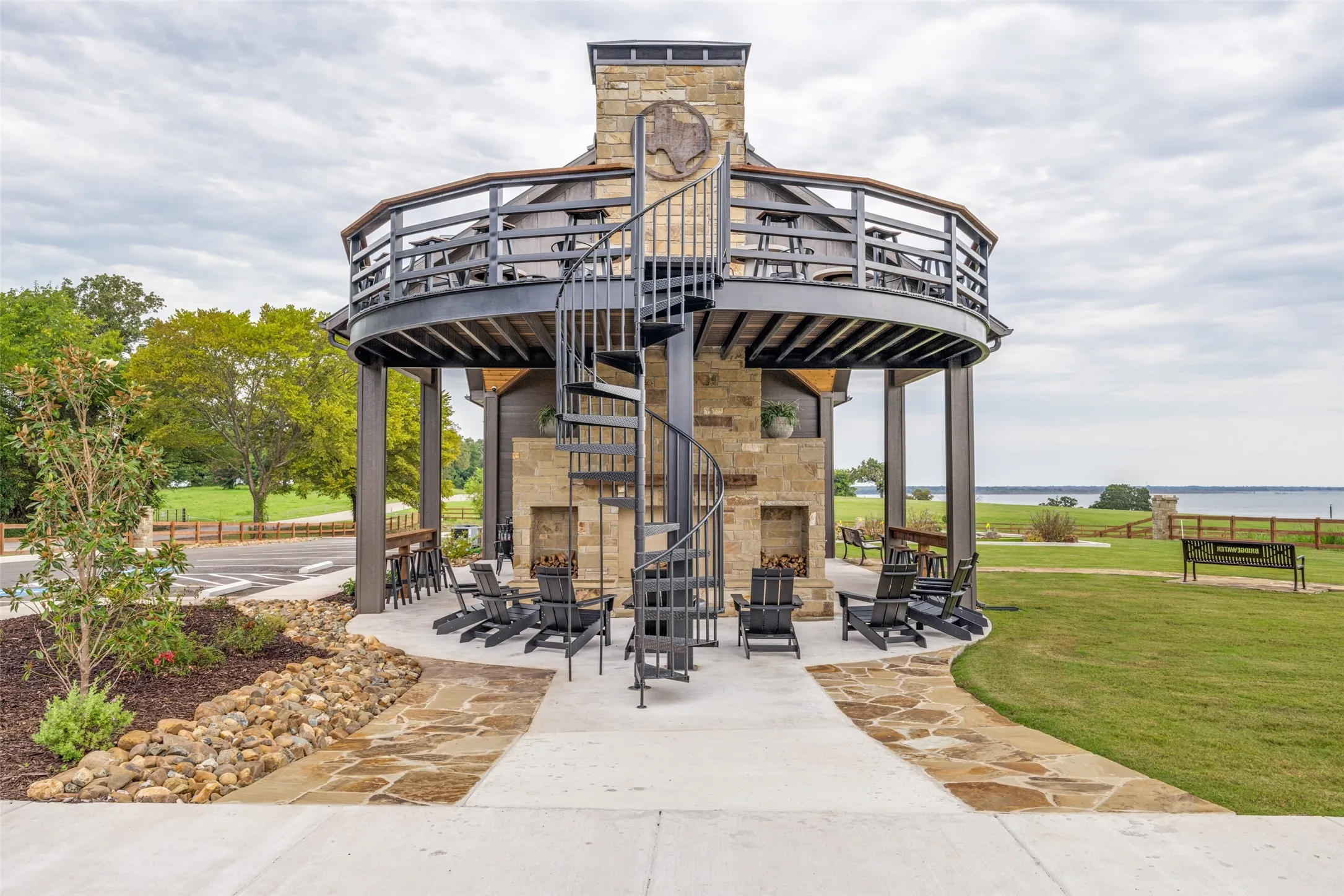 Surrounding community with a patio area, stairway, a lawn, and a deck with water view