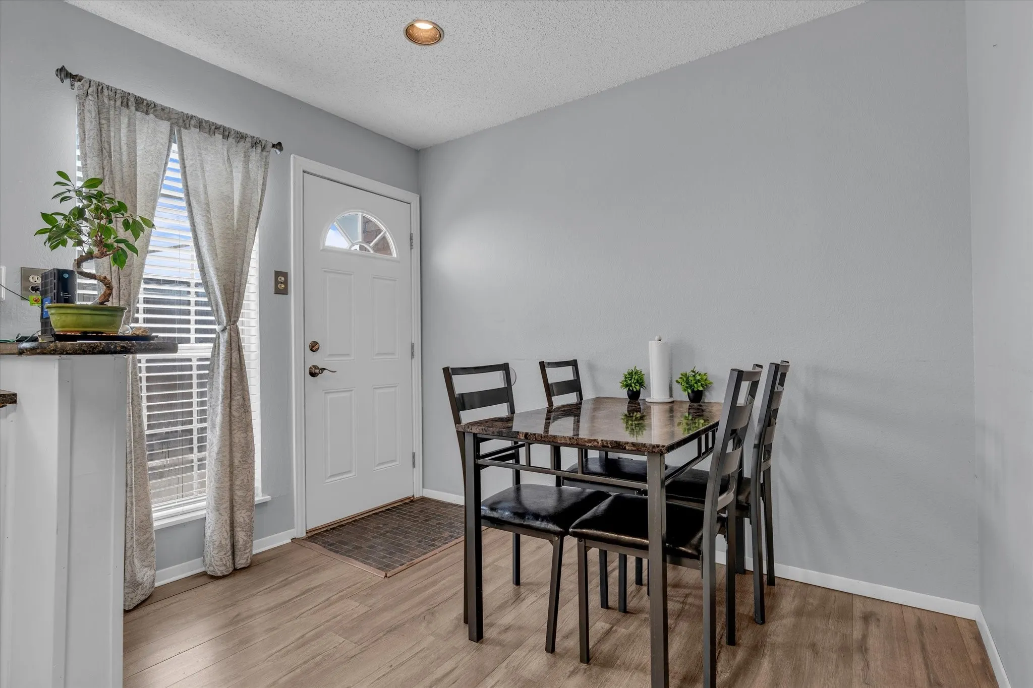 Dining space featuring a textured ceiling and light wood-style flooring