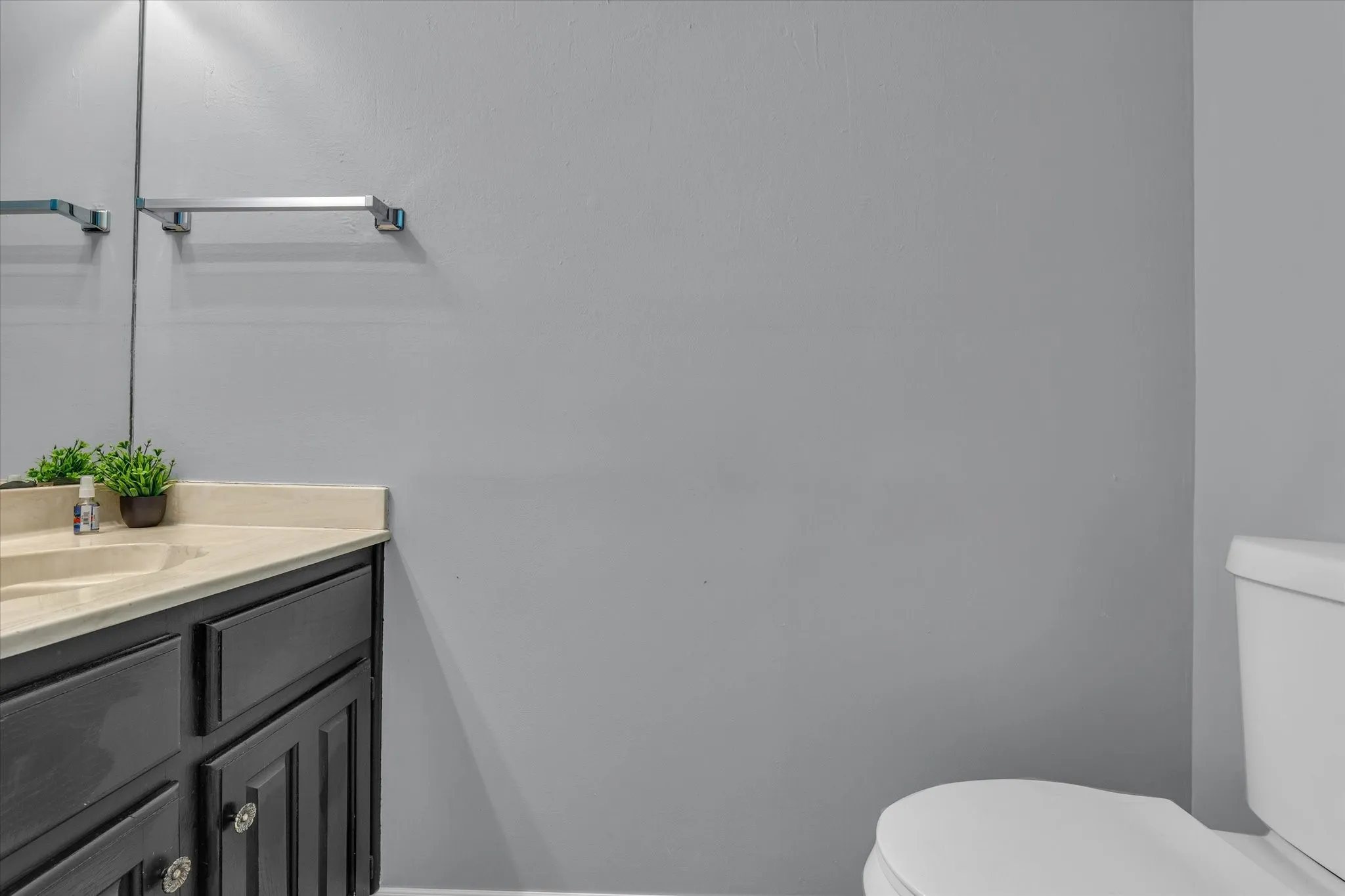 Half bathroom featuring toilet and vanity
