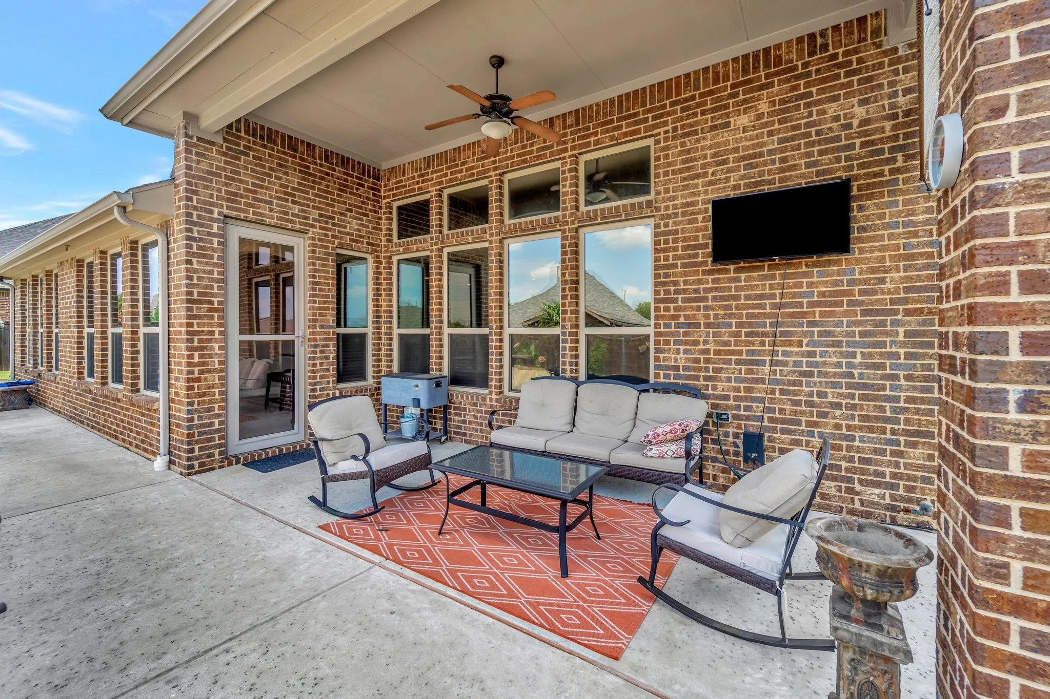 Covered patio with ceiling fan, extended concrete, plumbed for gas to add an outdoor kitchen or fireplace.