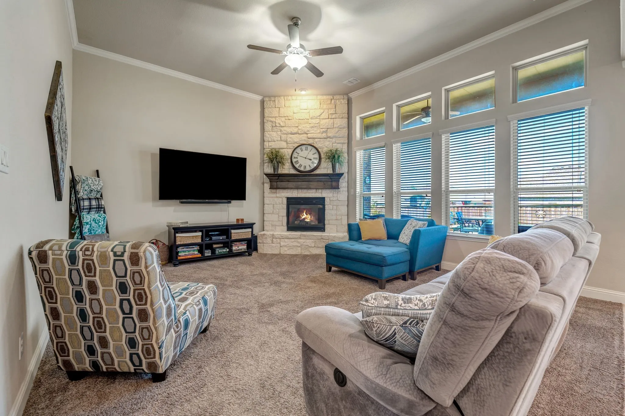 Living area with crown molding and stone fireplace!