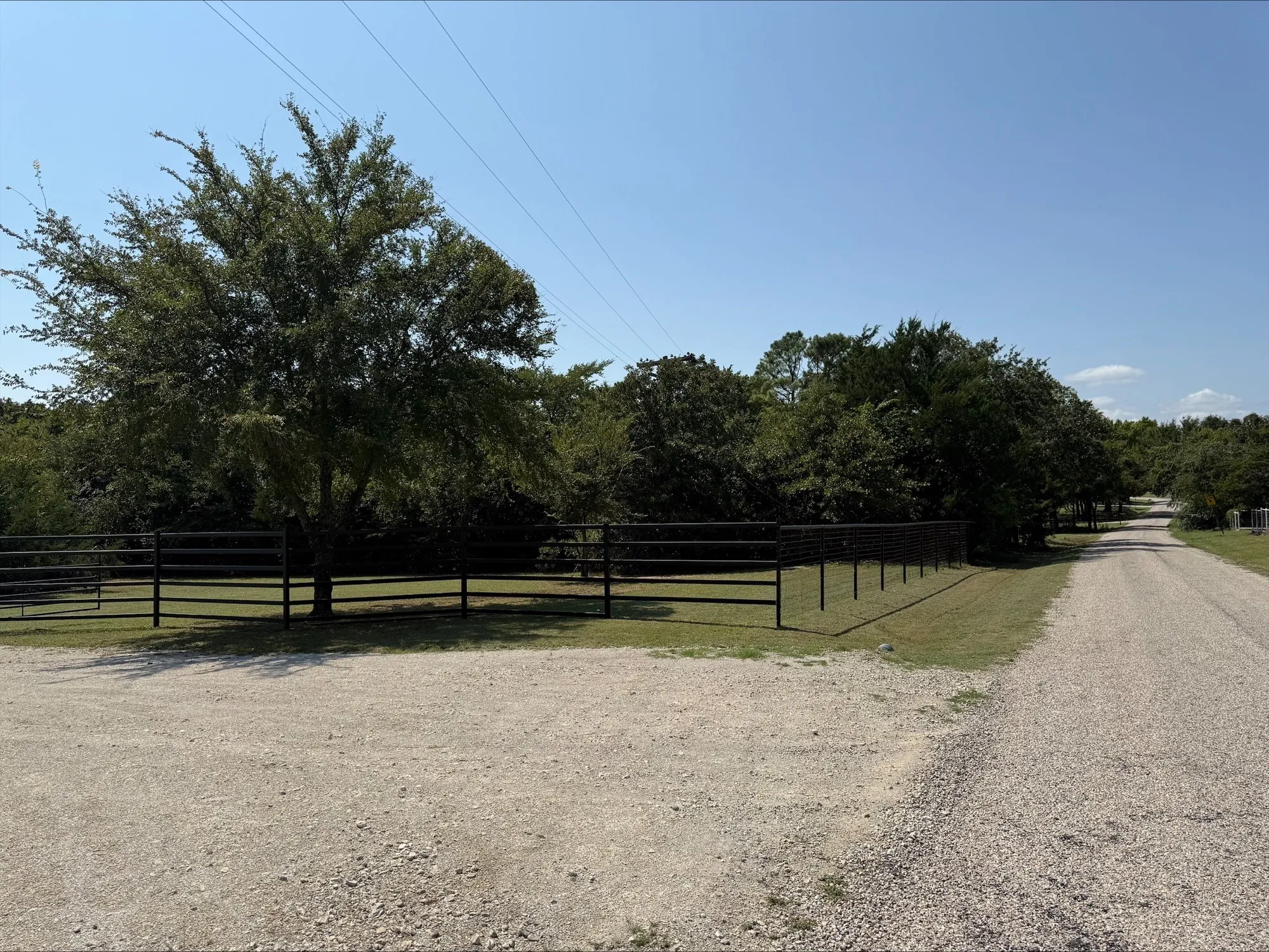 View of dirt / gravel road featuring a gate