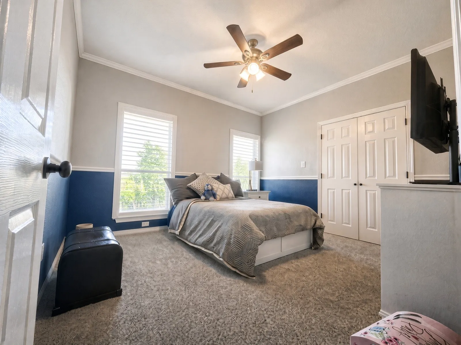 Recessed window, white window blinds, wall-mounted ceiling fan, crown molding, and paneled closet doors