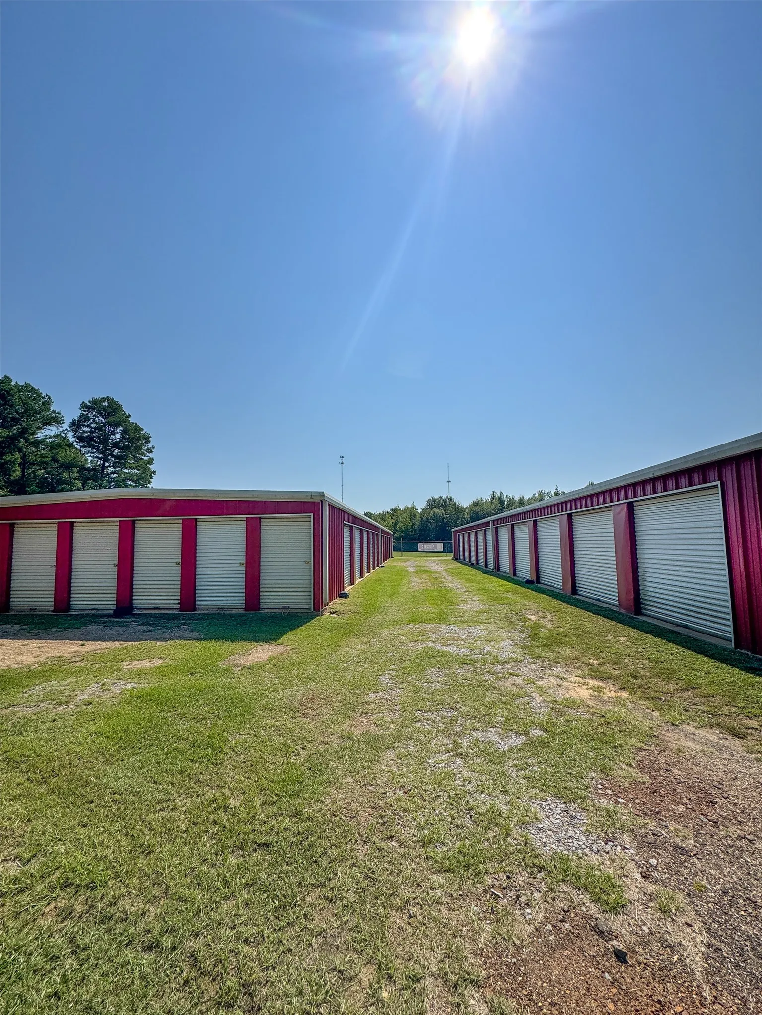 View of green lawn with an outdoor structure and an outbuilding