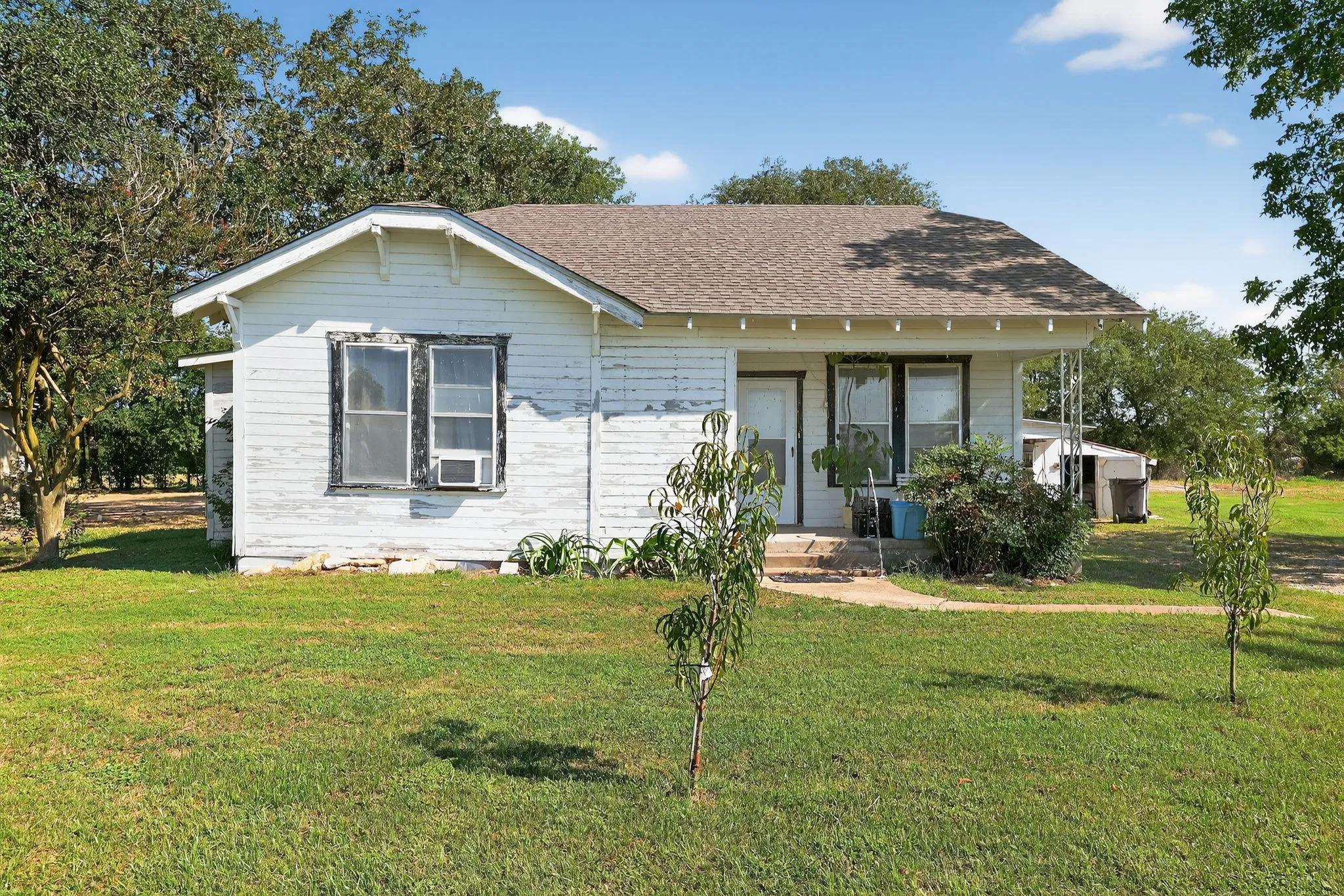 View of front facade with a front lawn and roof with shingles