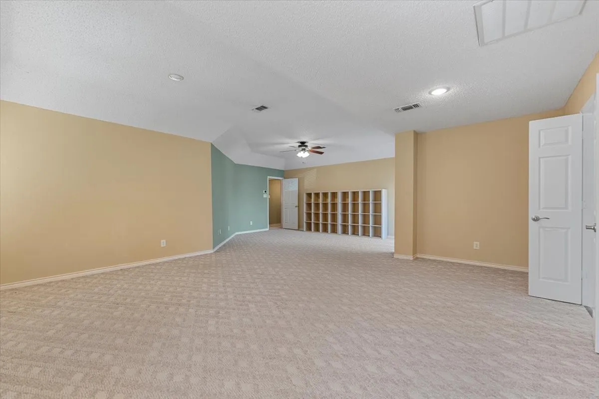Unfurnished room featuring light carpet, a textured ceiling, and recessed lighting