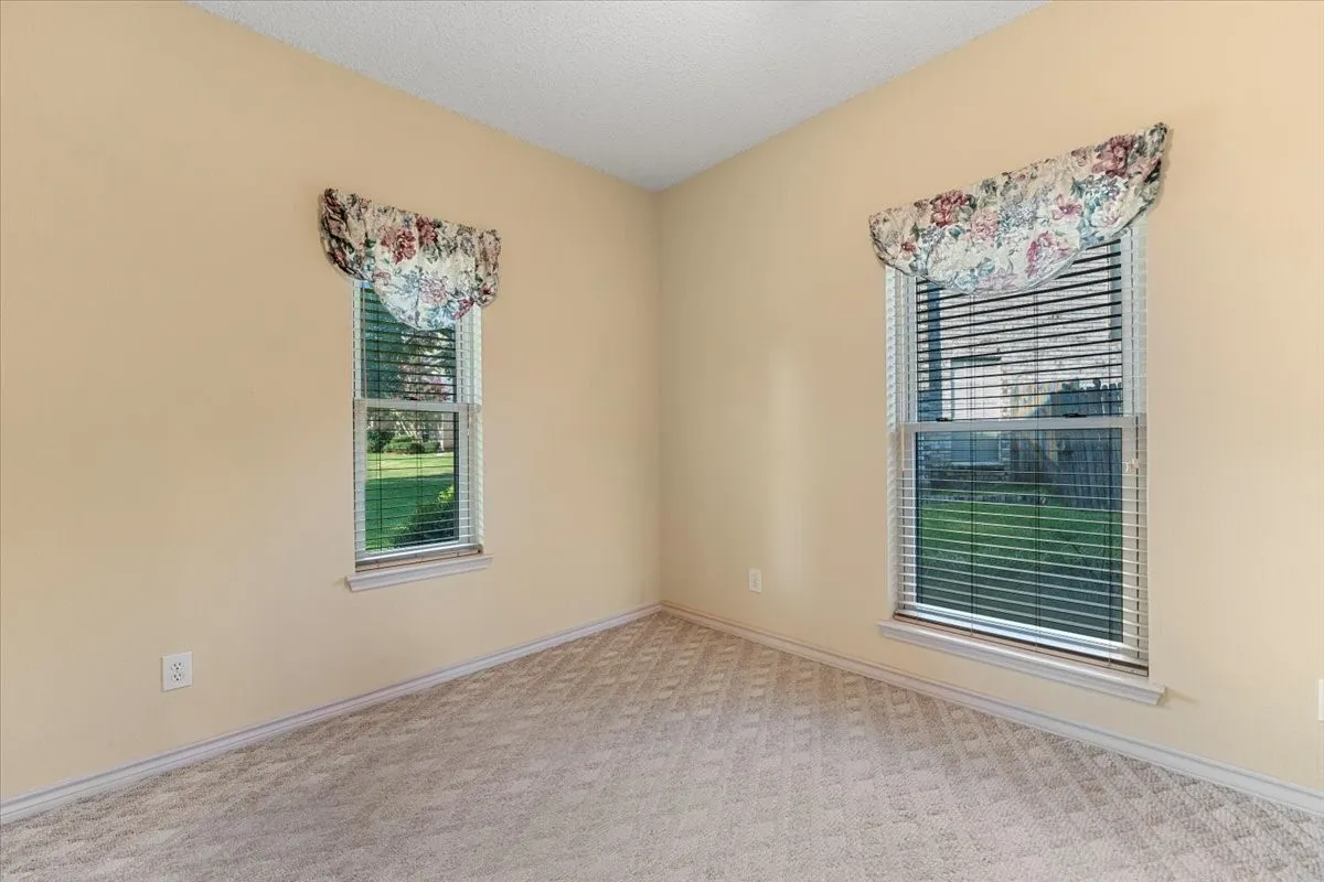 Carpeted spare room with baseboards and a textured ceiling