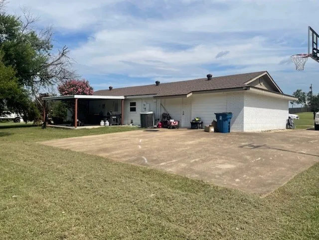 Rear view of property featuring a yard