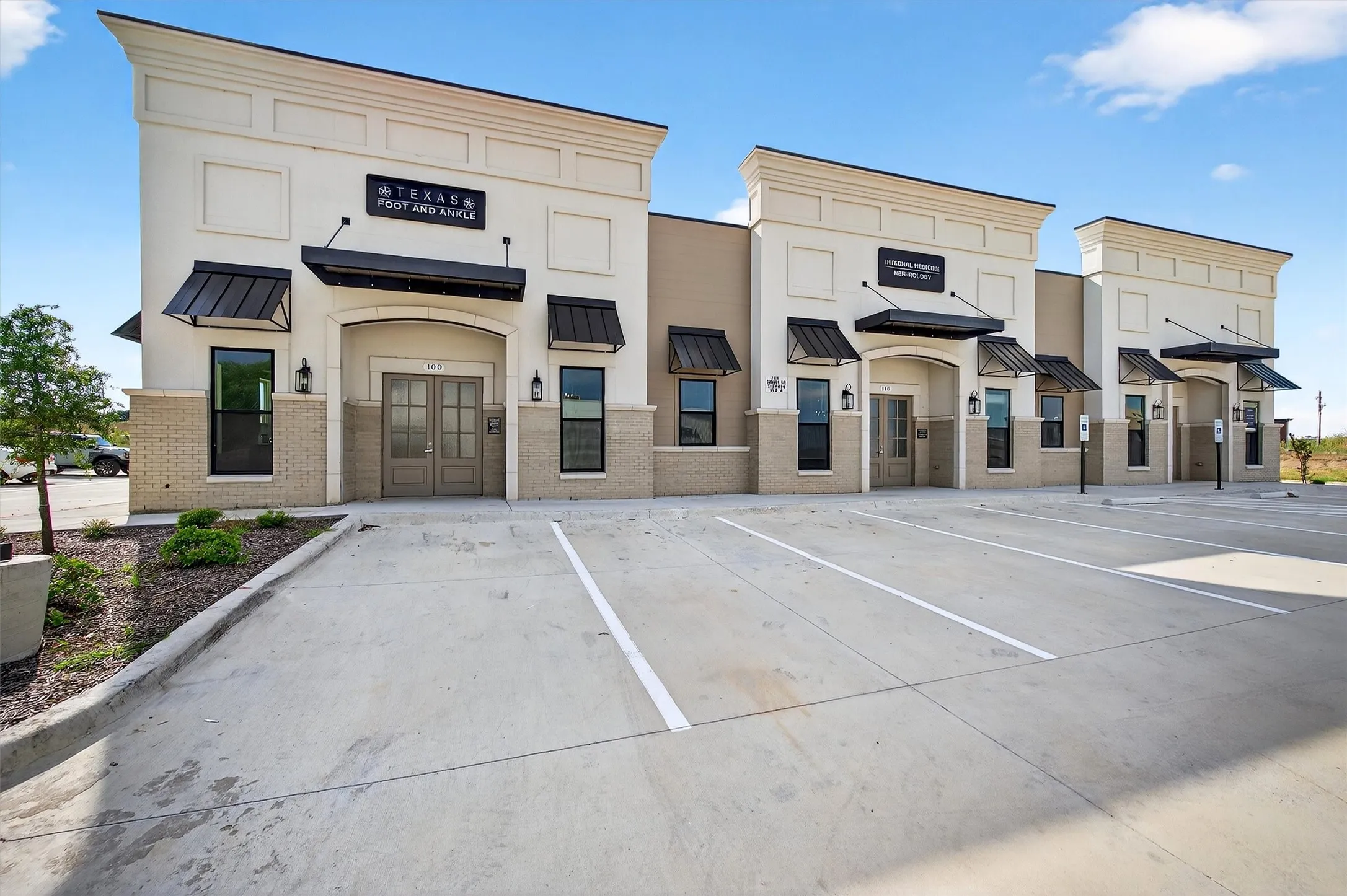 View of building exterior featuring uncovered parking