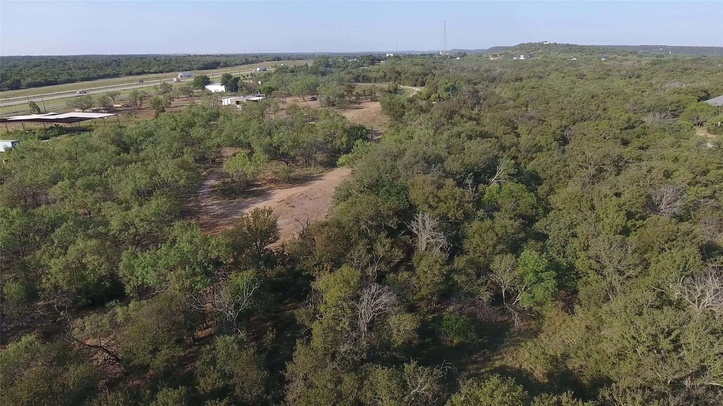 View of property location featuring a heavily wooded area