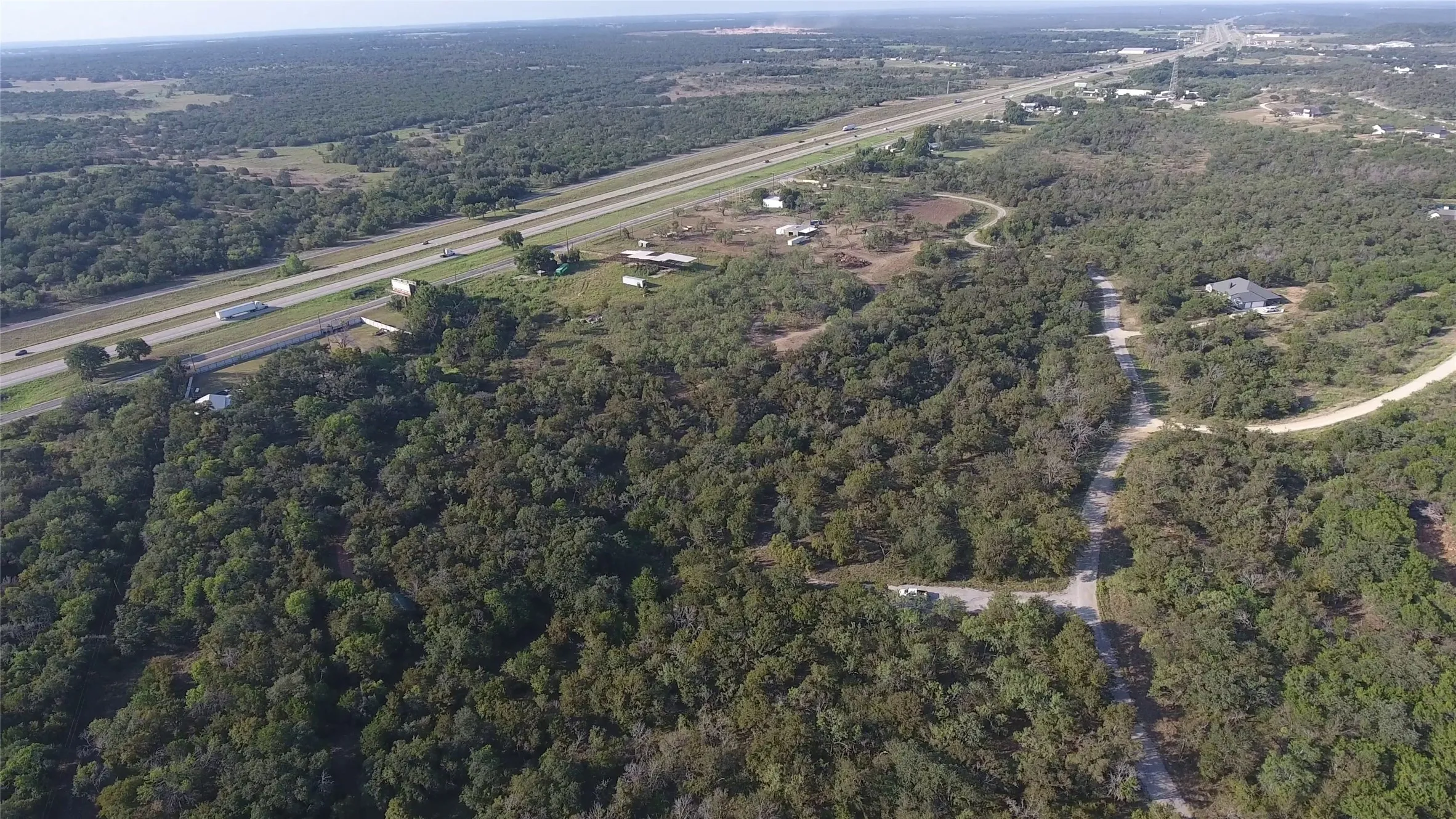 View of property location featuring a forest